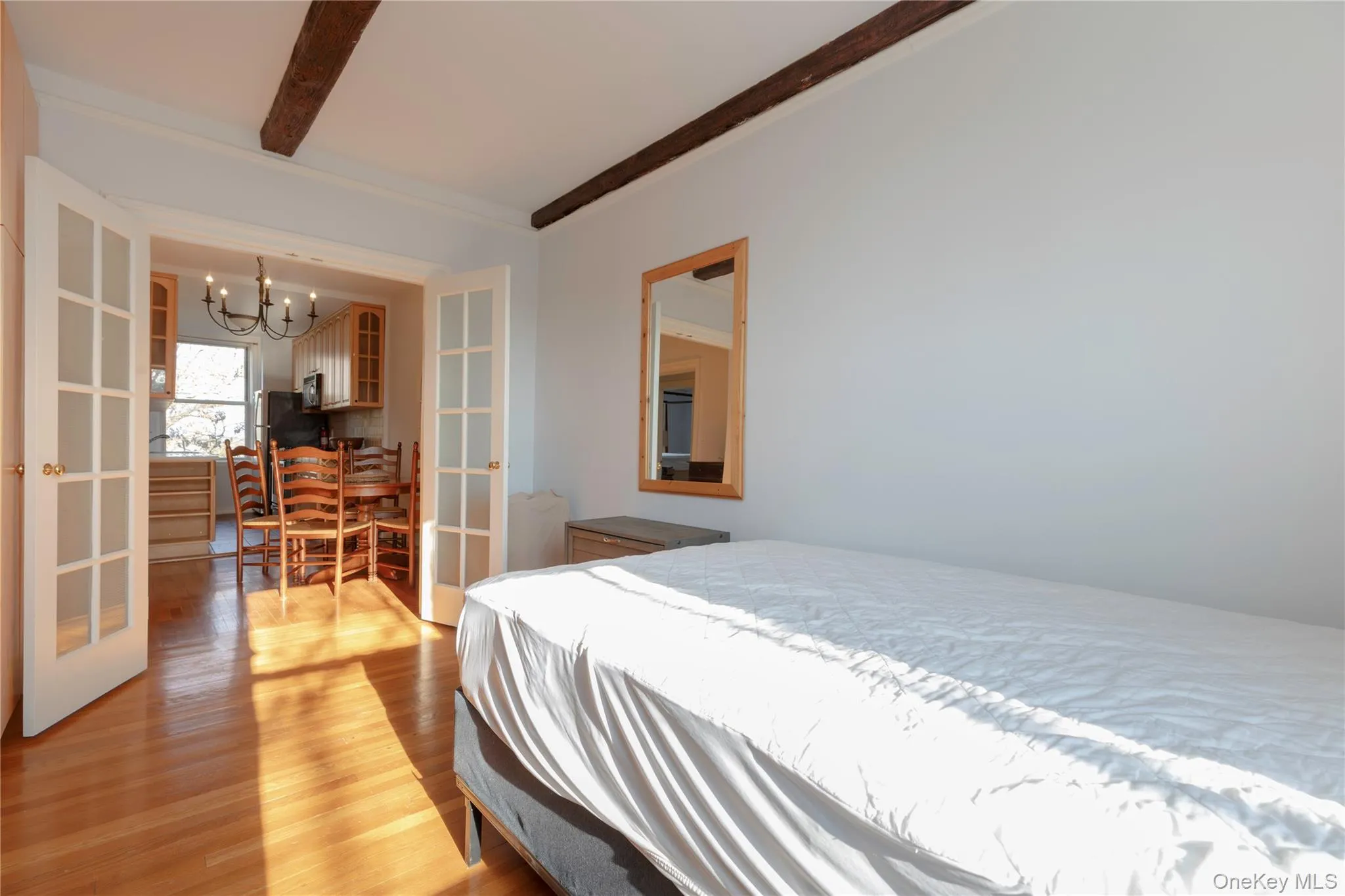 Bedroom/den/office/living room with a fireplace, beamed ceiling Bedroom/den/office/living room with a fireplace, beamed ceiling