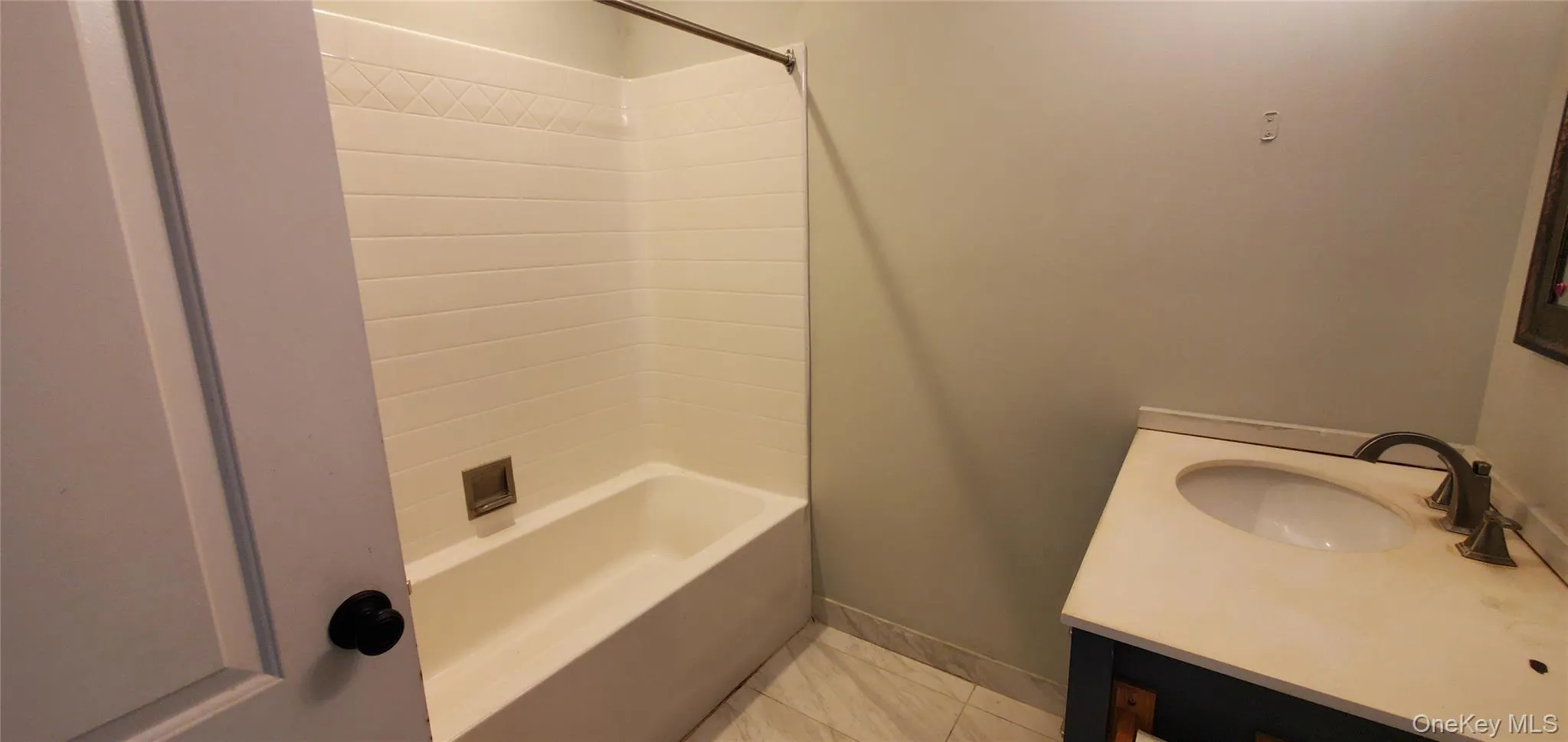 Bathroom featuring vanity and washtub / shower combination Bathroom featuring vanity and washtub / shower combination