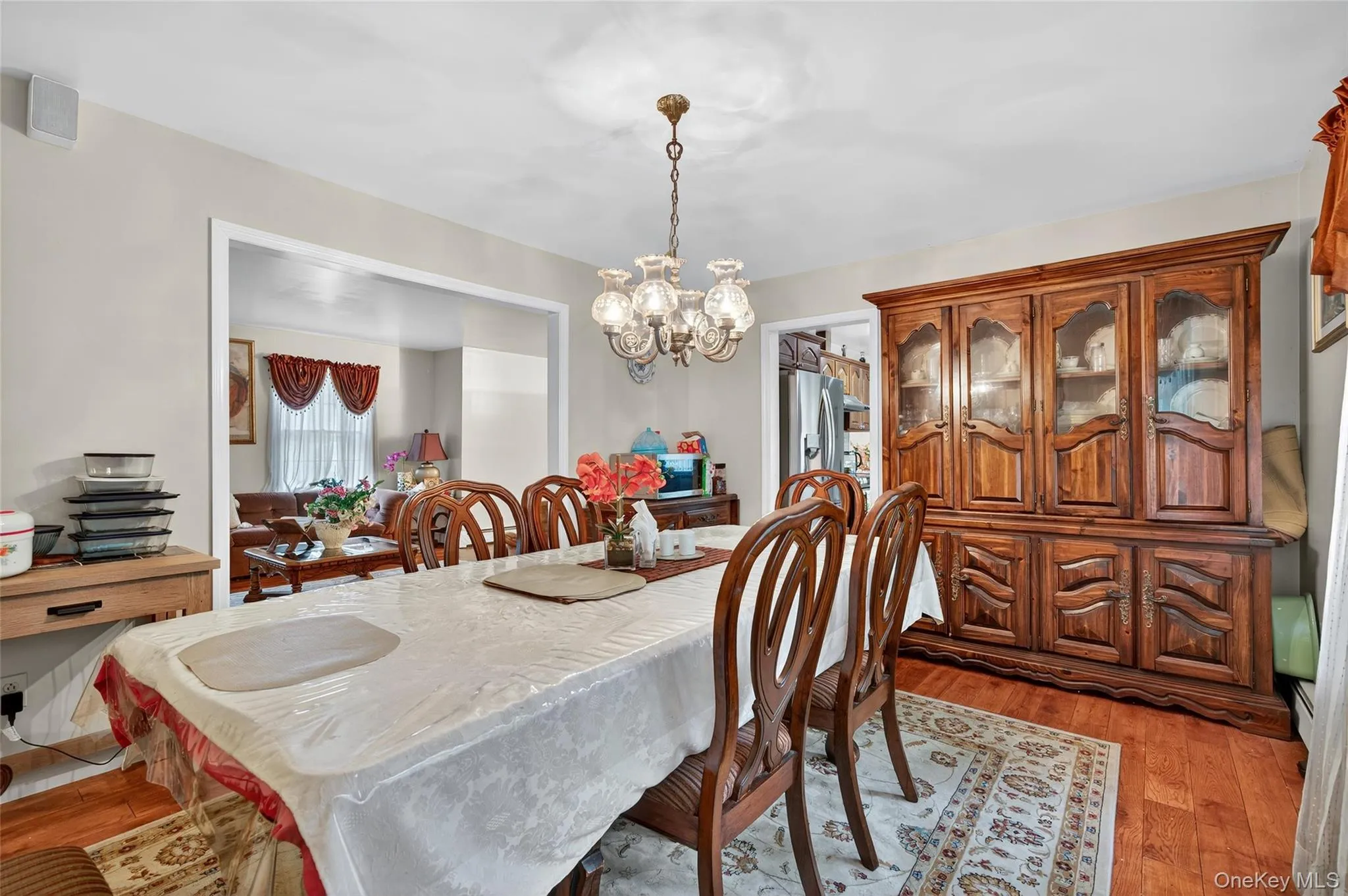 Dining space with light wood-type flooring and a chandelier Dining space with light wood-type flooring and a chandelier