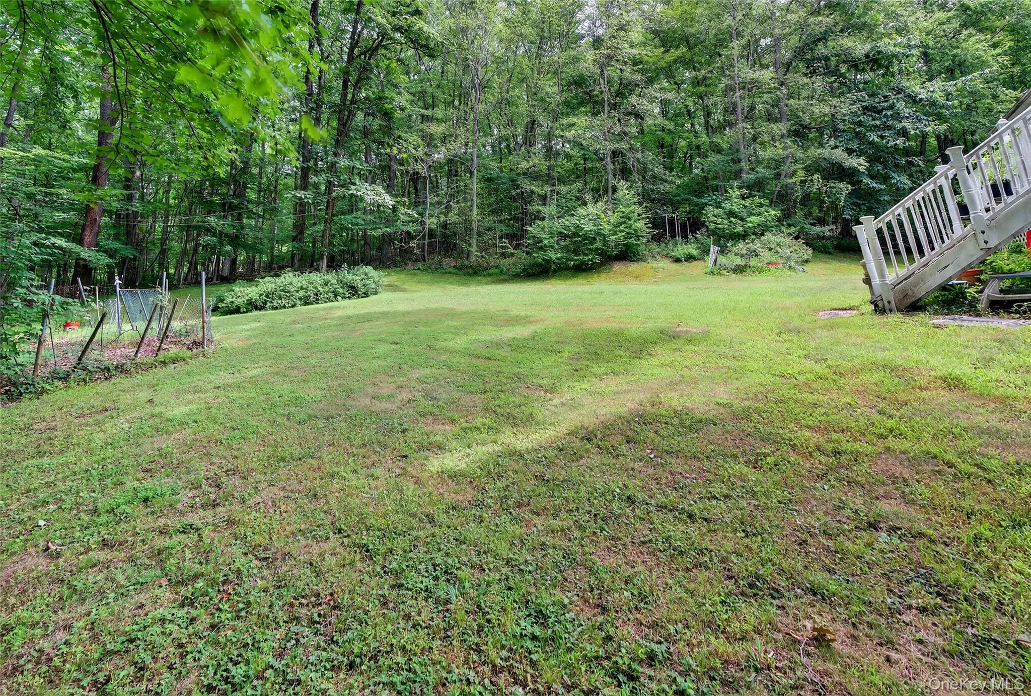 View of grassy yard featuring stairs View of grassy yard featuring stairs