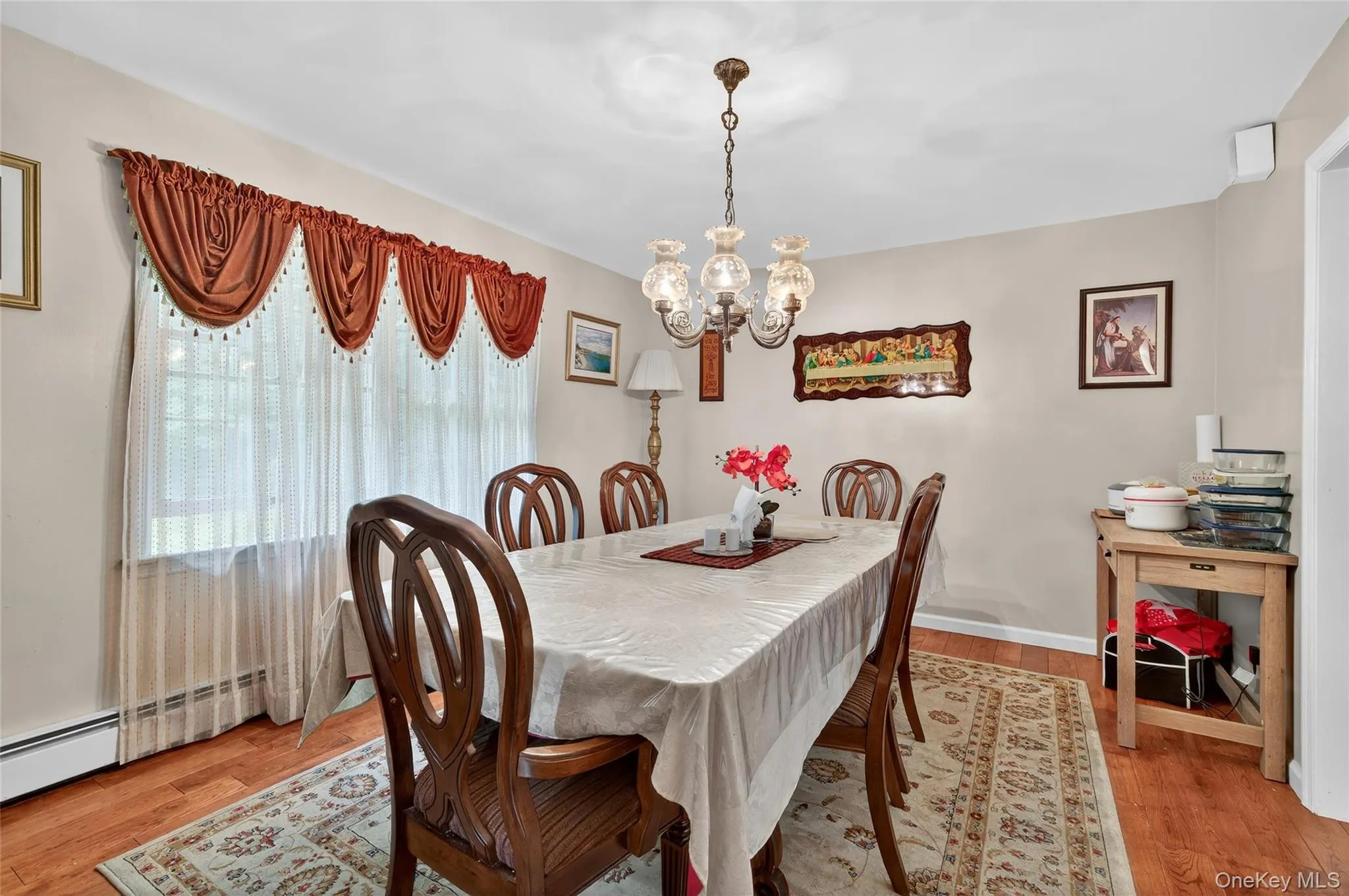 Dining space with light wood-style floors and a chandelier Dining space with light wood-style floors and a chandelier