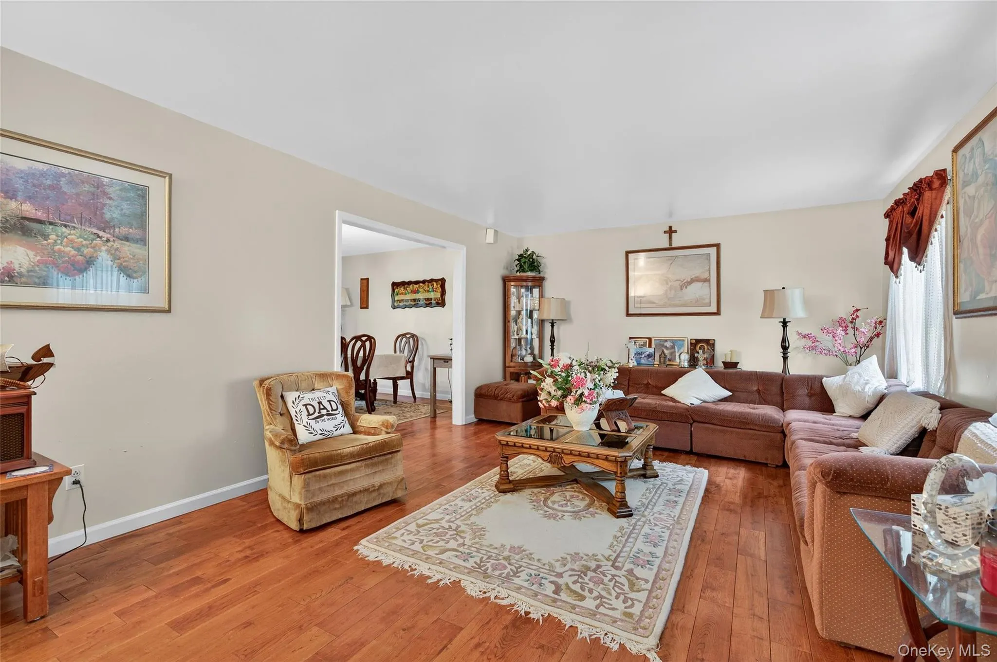 Living area featuring hardwood / wood-style flooring and baseboards Living area featuring hardwood / wood-style flooring and baseboards