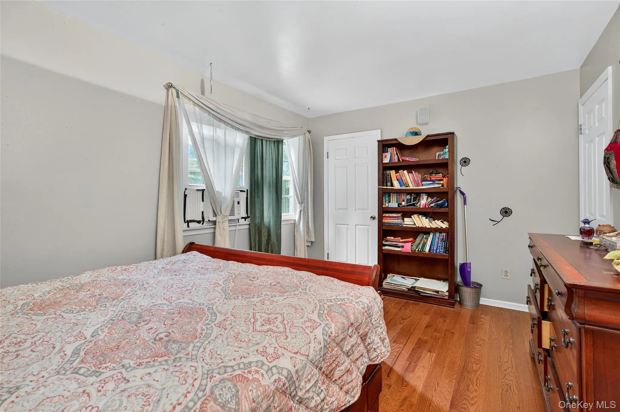 Bedroom featuring light wood-type flooring and baseboards Bedroom featuring light wood-type flooring and baseboards