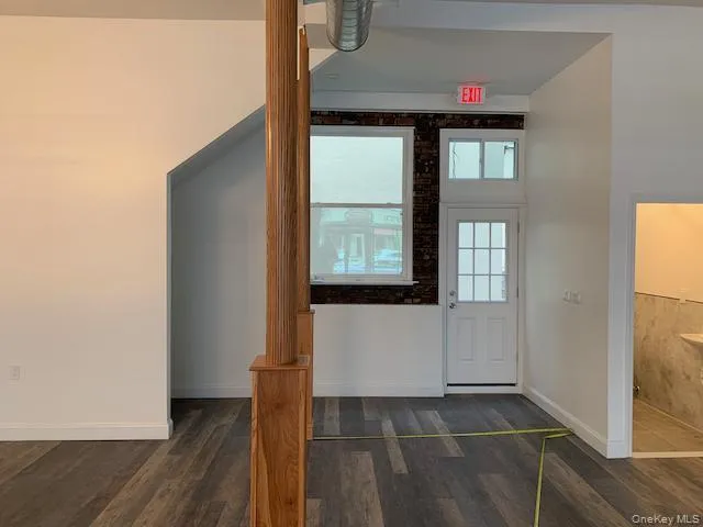 Entryway featuring dark wood-style floors and baseboards Entryway featuring dark wood-style floors and baseboards