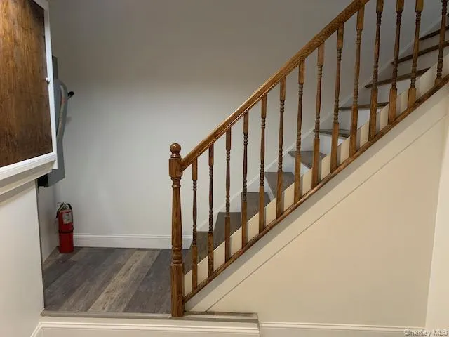 Staircase with baseboards and wood finished floors Staircase with baseboards and wood finished floors