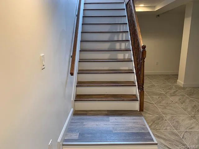 Stairs with baseboards and wood finished floors Stairs with baseboards and wood finished floors