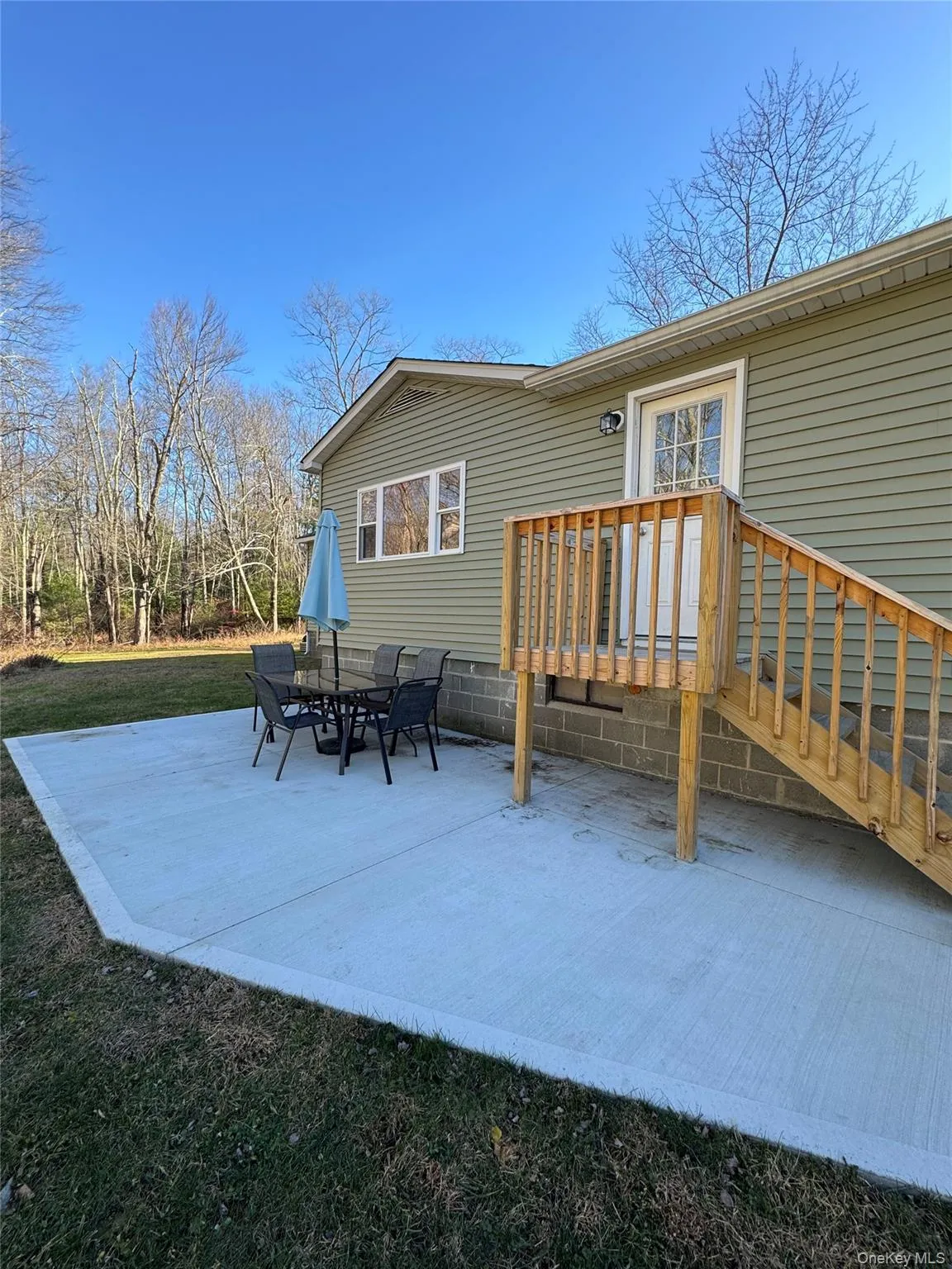View of patio with a wooden deck View of patio with a wooden deck