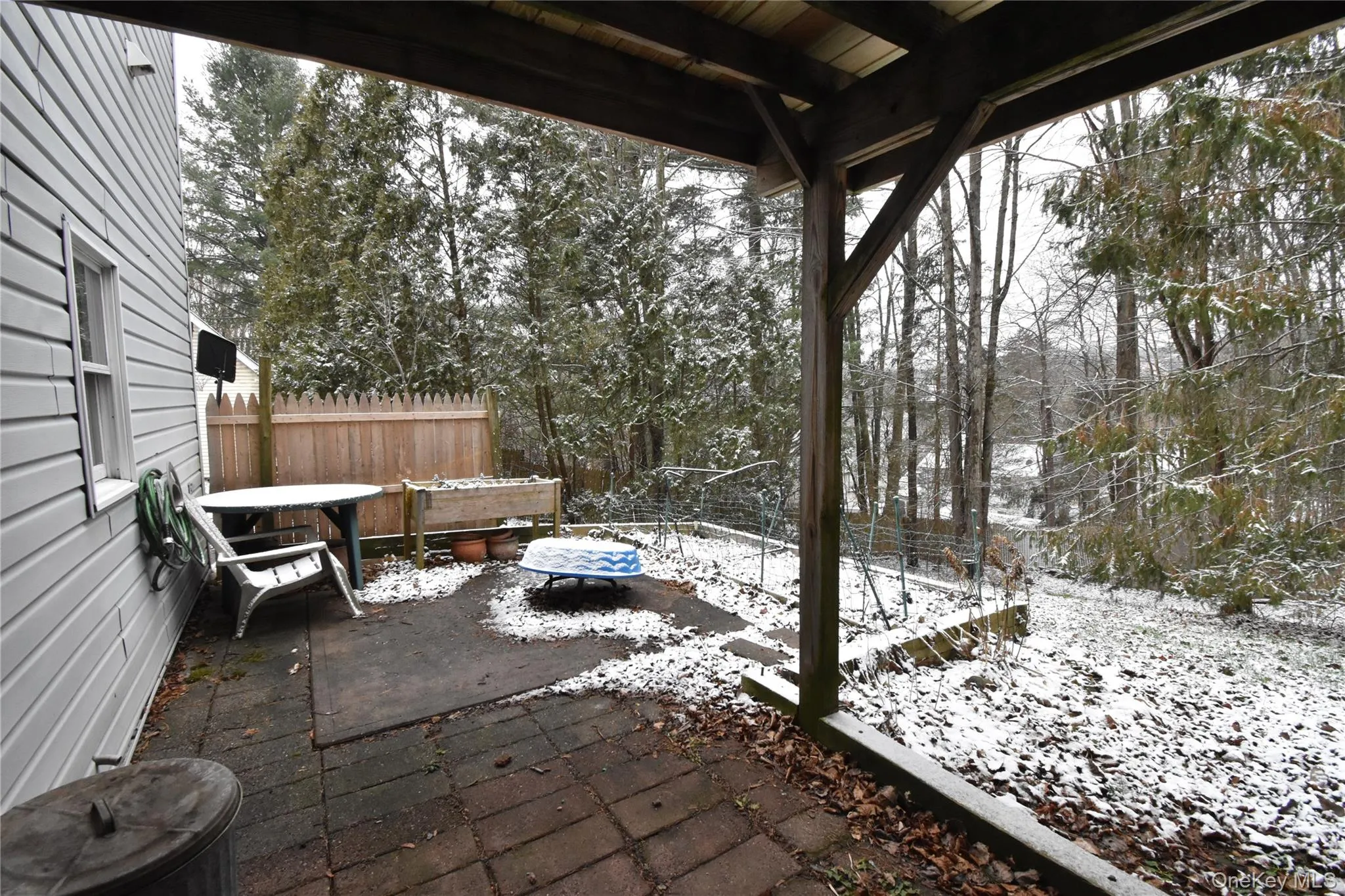 Snow covered patio with a patio Snow covered patio with a patio