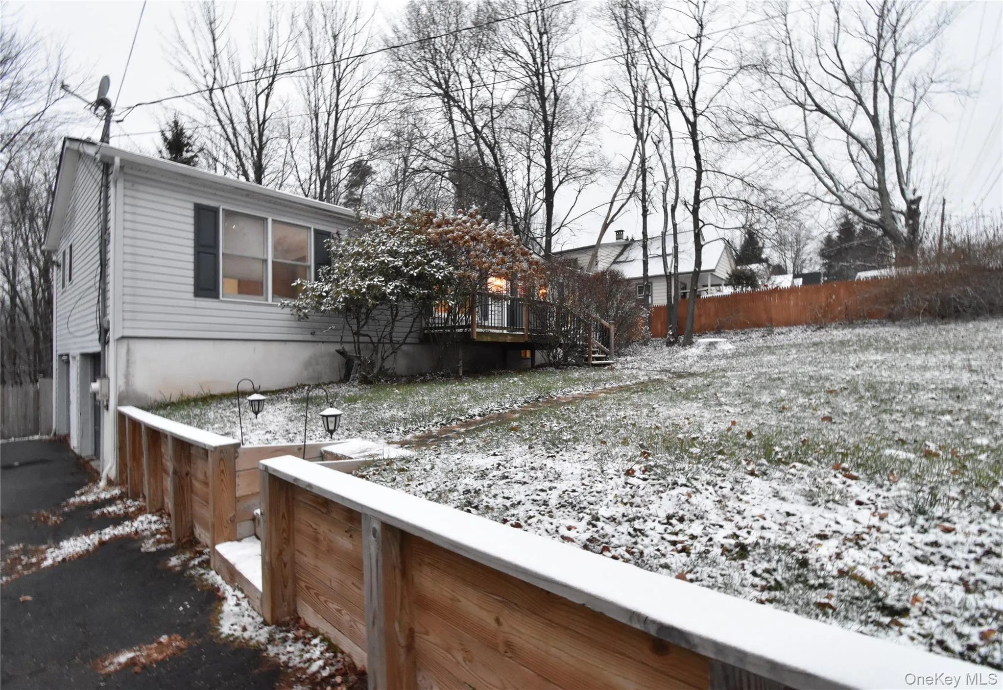 View of home's exterior featuring a wooden deck View of home's exterior featuring a wooden deck