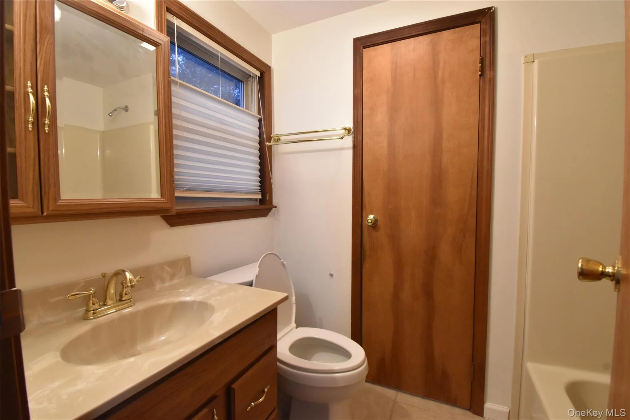 Bathroom featuring vanity and light tile patterned flooring Bathroom featuring vanity and light tile patterned flooring