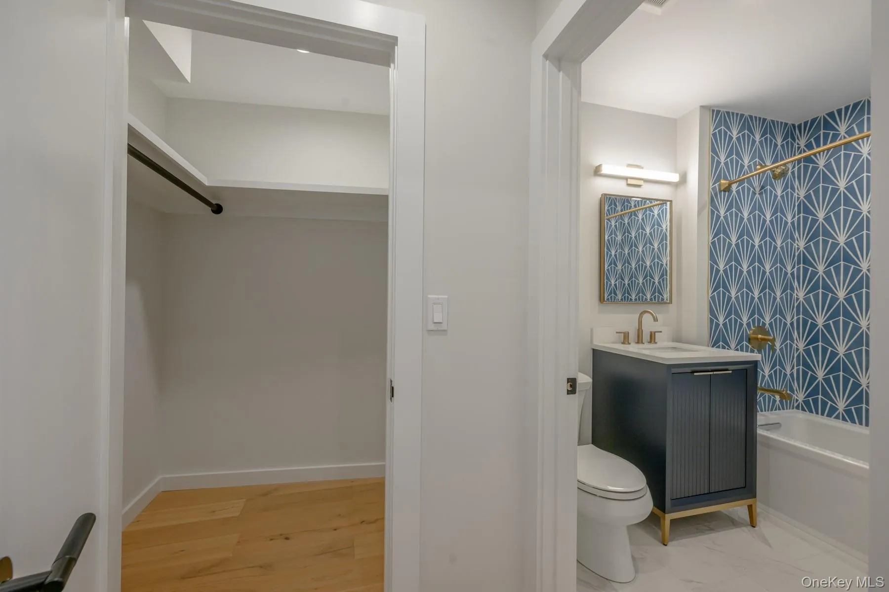 Bathroom with vanity, shower / bathtub combination with curtain, and a spacious closet Bathroom with vanity, shower / bathtub combination with curtain, and a spacious closet