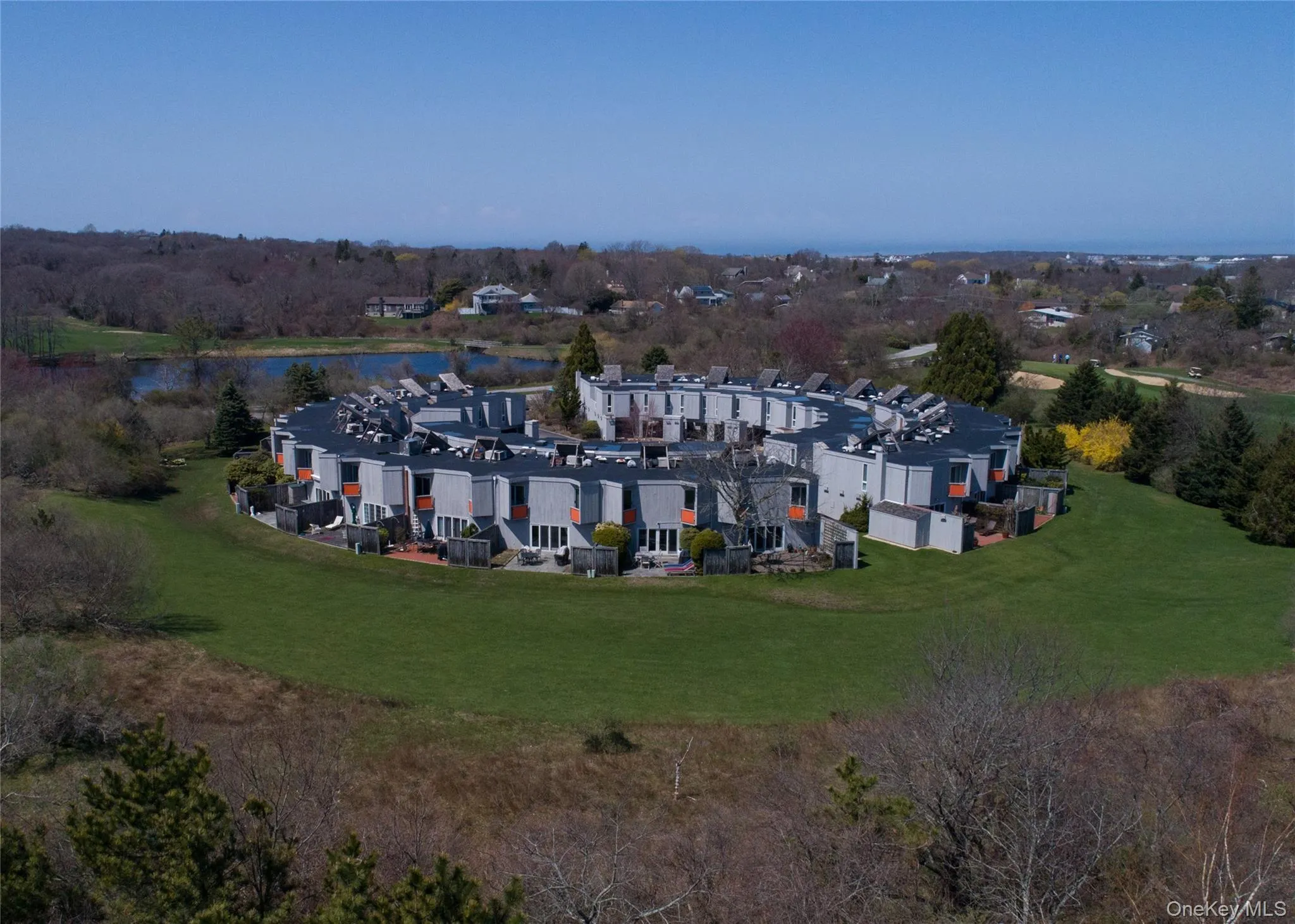 Aerial view of property and surrounding area featuring a nearby body of water and a tree filled landscape Aerial view of property and surrounding area featuring a nearby body of water and a tree filled landscape