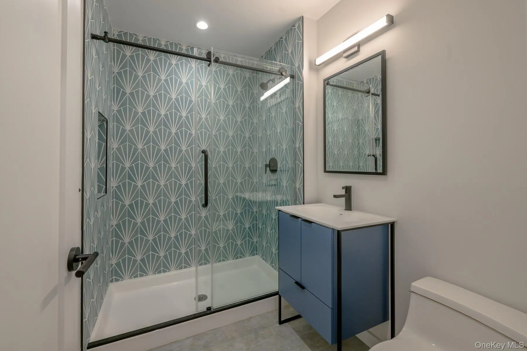 Bathroom with vanity and a stall shower Bathroom with vanity and a stall shower