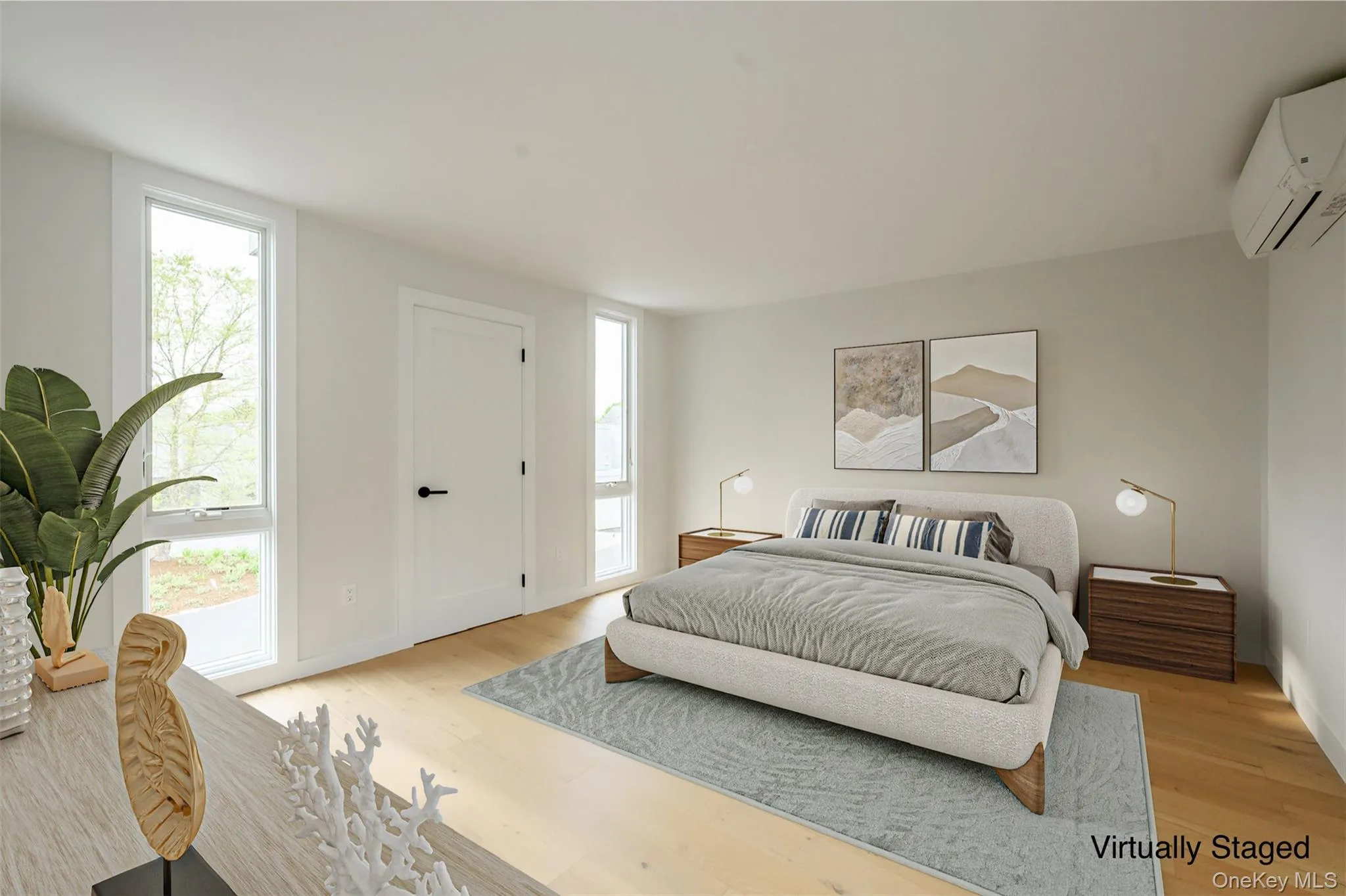 Bedroom featuring light wood-type flooring and an AC wall unit Bedroom featuring light wood-type flooring and an AC wall unit