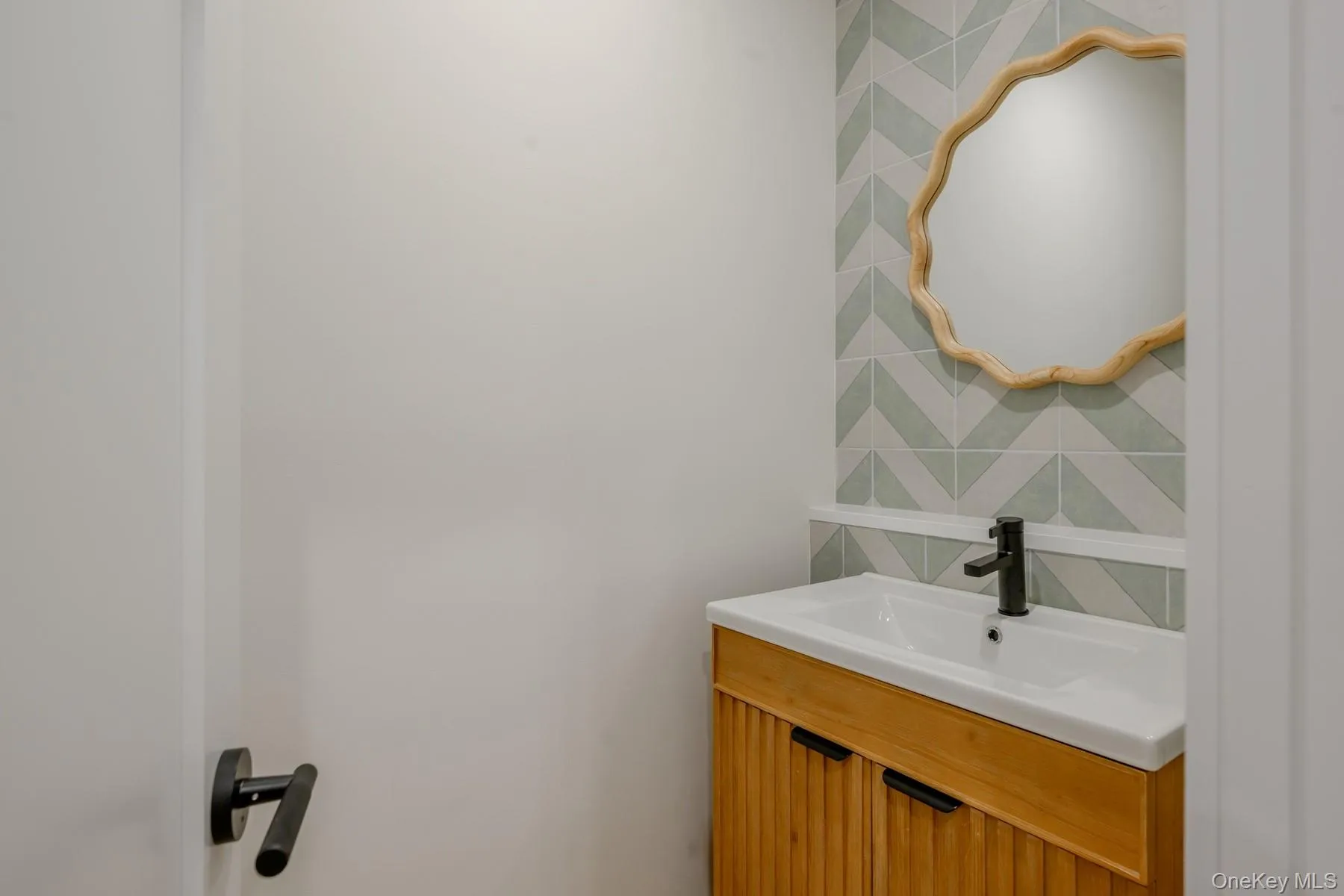 Bathroom featuring decorative backsplash and vanity Bathroom featuring decorative backsplash and vanity