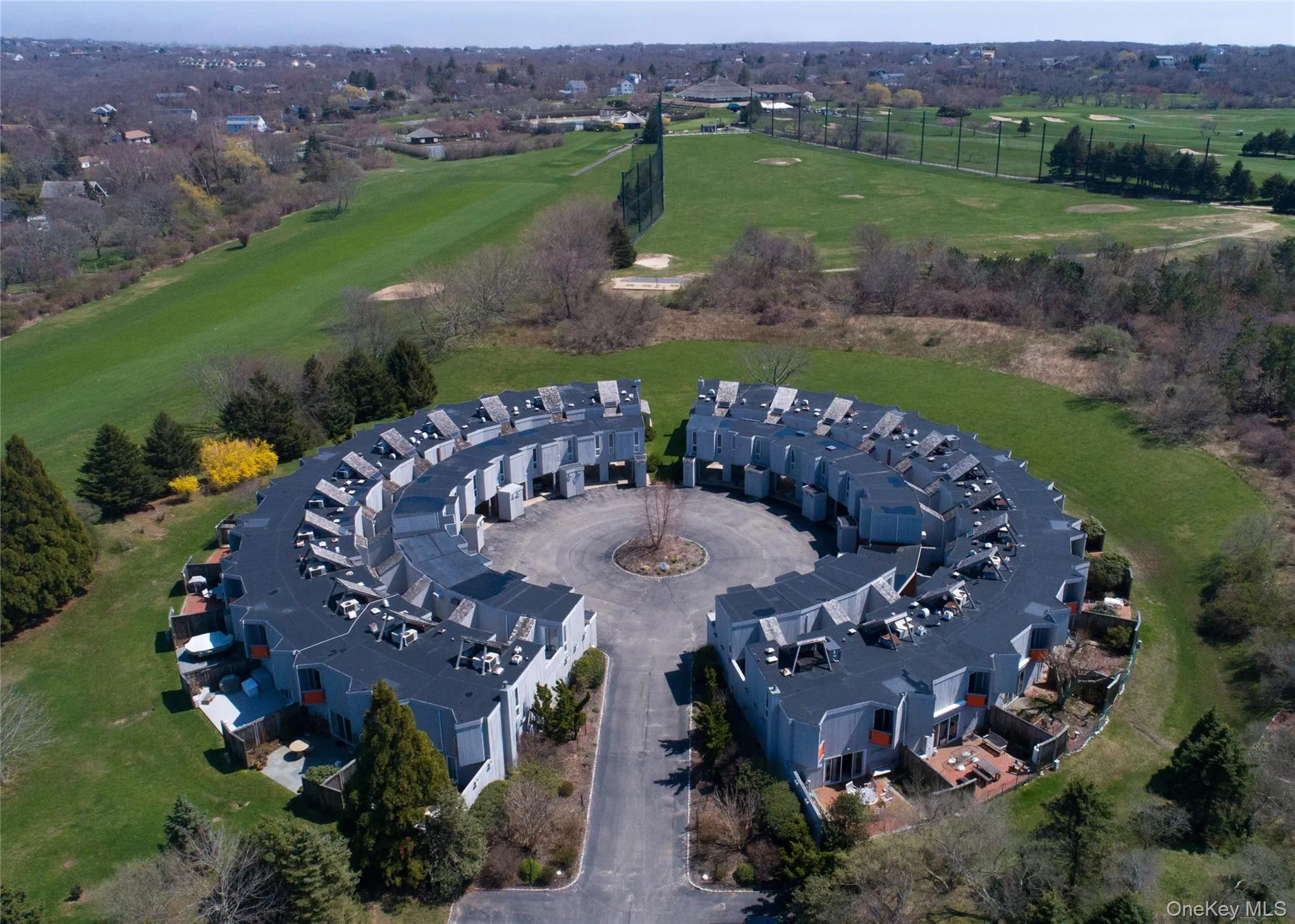 Aerial overview of property's location with a golf course Aerial overview of property's location with a golf course