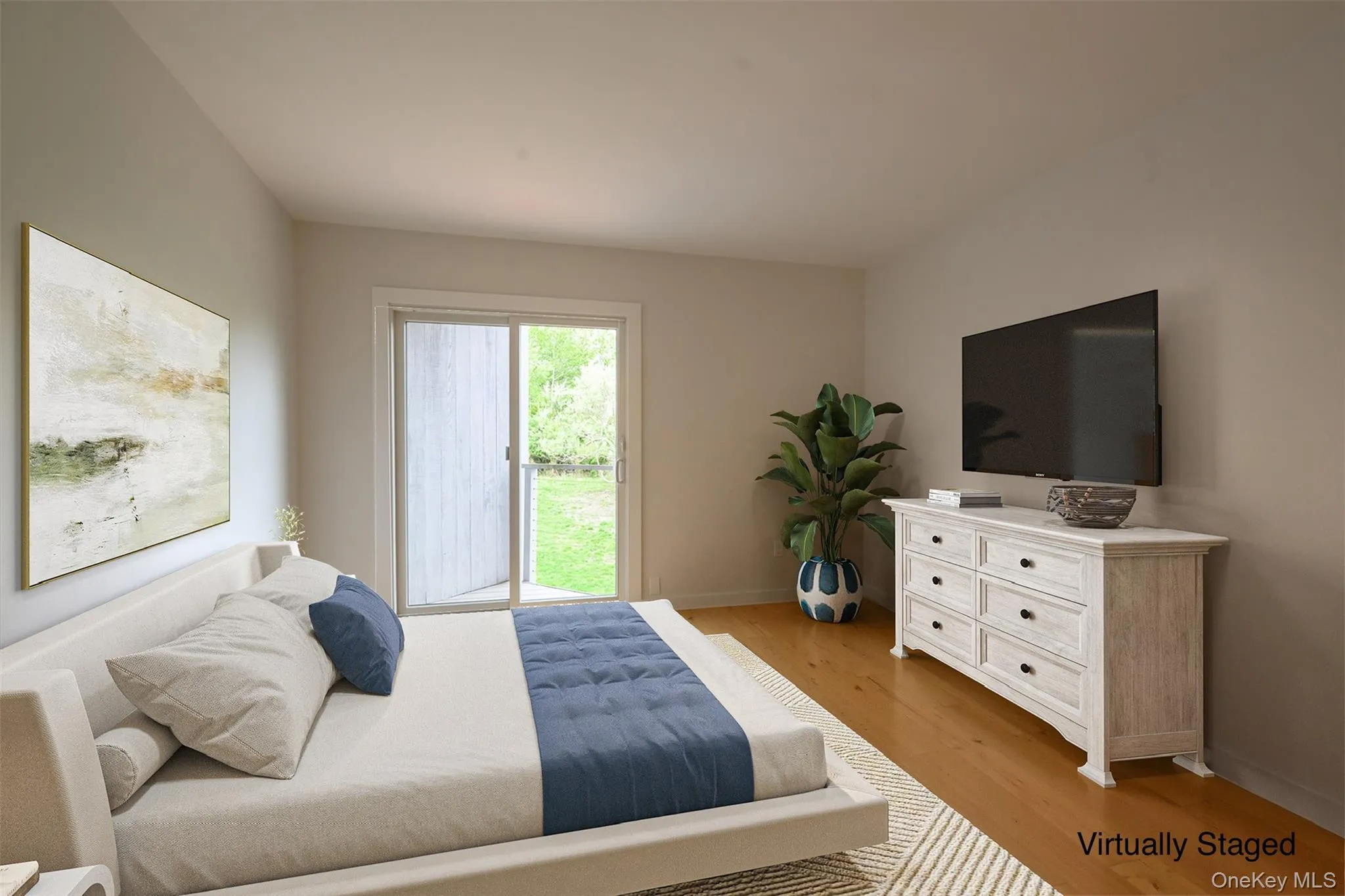 Bedroom featuring light wood-type flooring and baseboards Bedroom featuring light wood-type flooring and baseboards