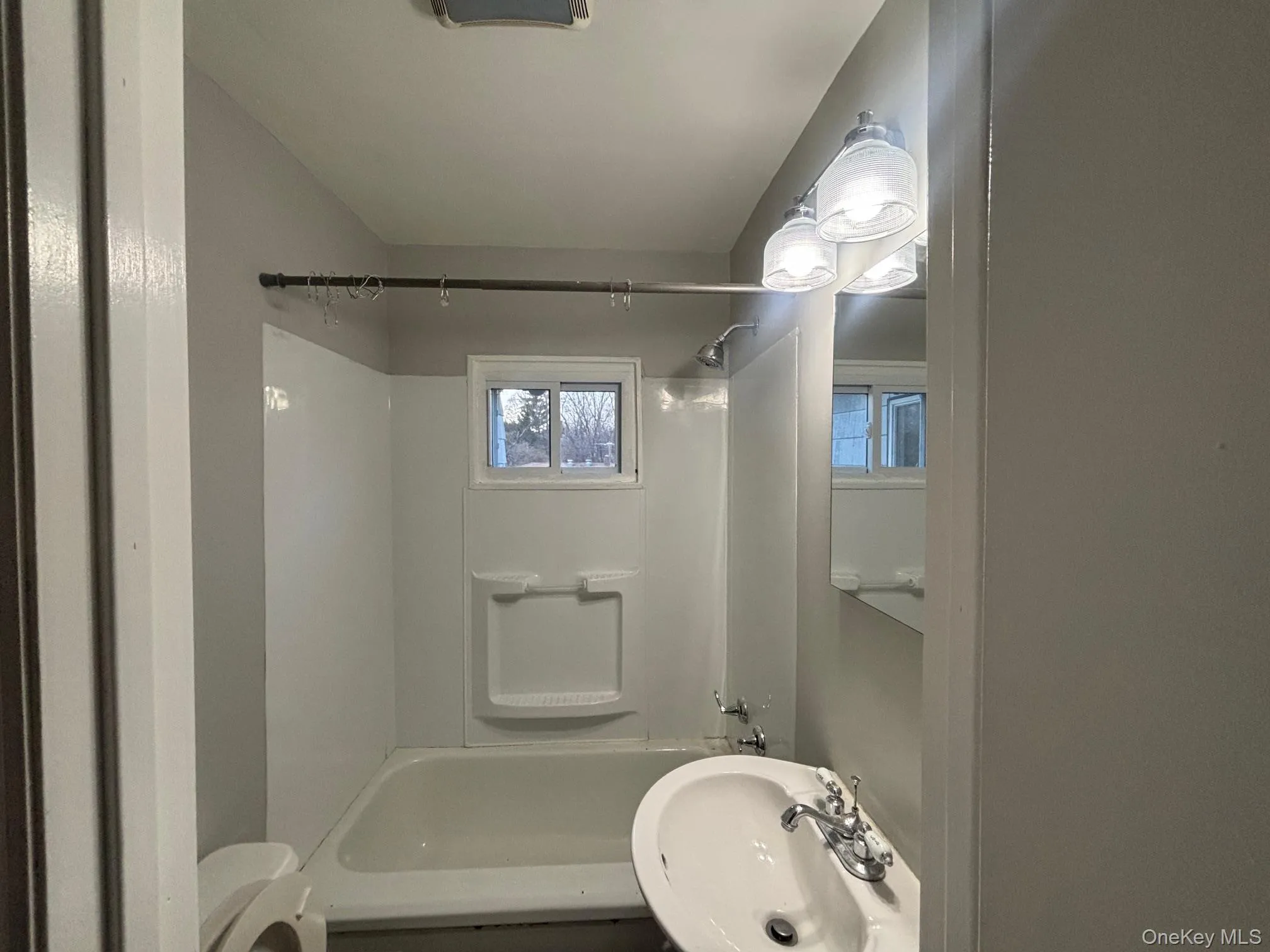 Bathroom with a sink and shower / tub combination Bathroom with a sink and shower / tub combination