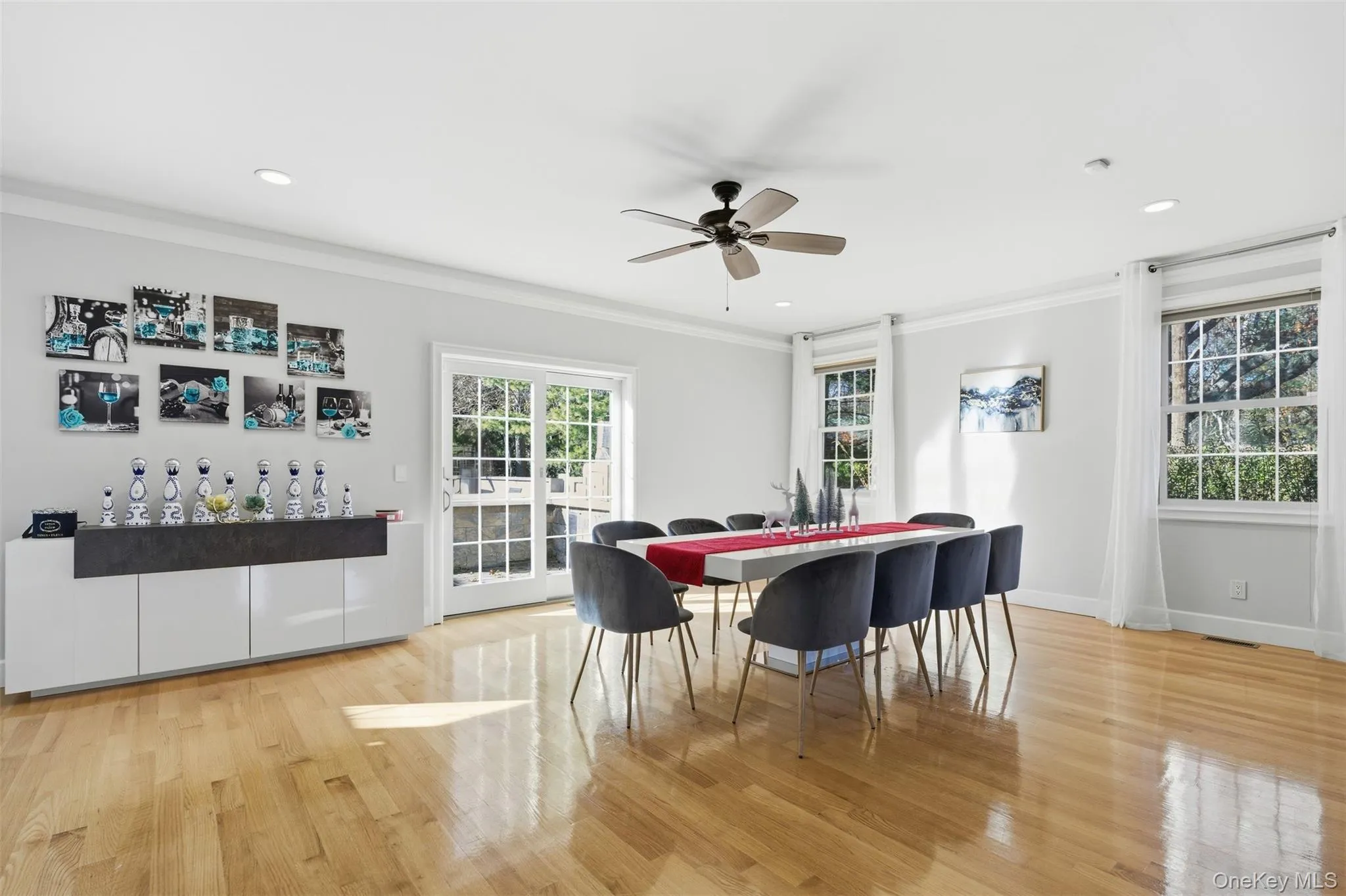 Dining space with ornamental molding, light wood-style floors, a ceiling fan, and recessed lighting Dining space with ornamental molding, light wood-style floors, a ceiling fan, and recessed lighting