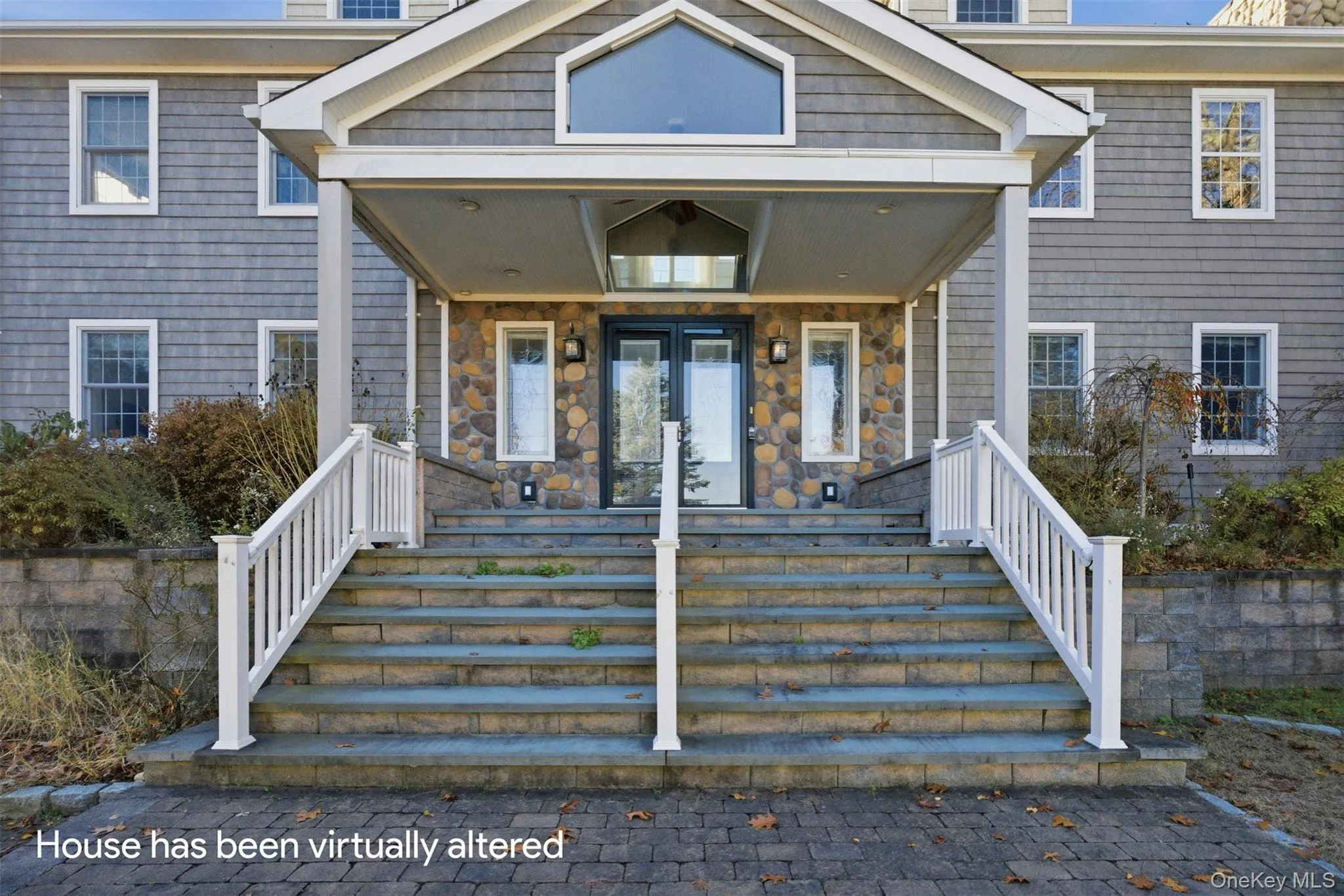 View of exterior entry featuring a porch, stone siding, and french doors View of exterior entry featuring a porch, stone siding, and french doors