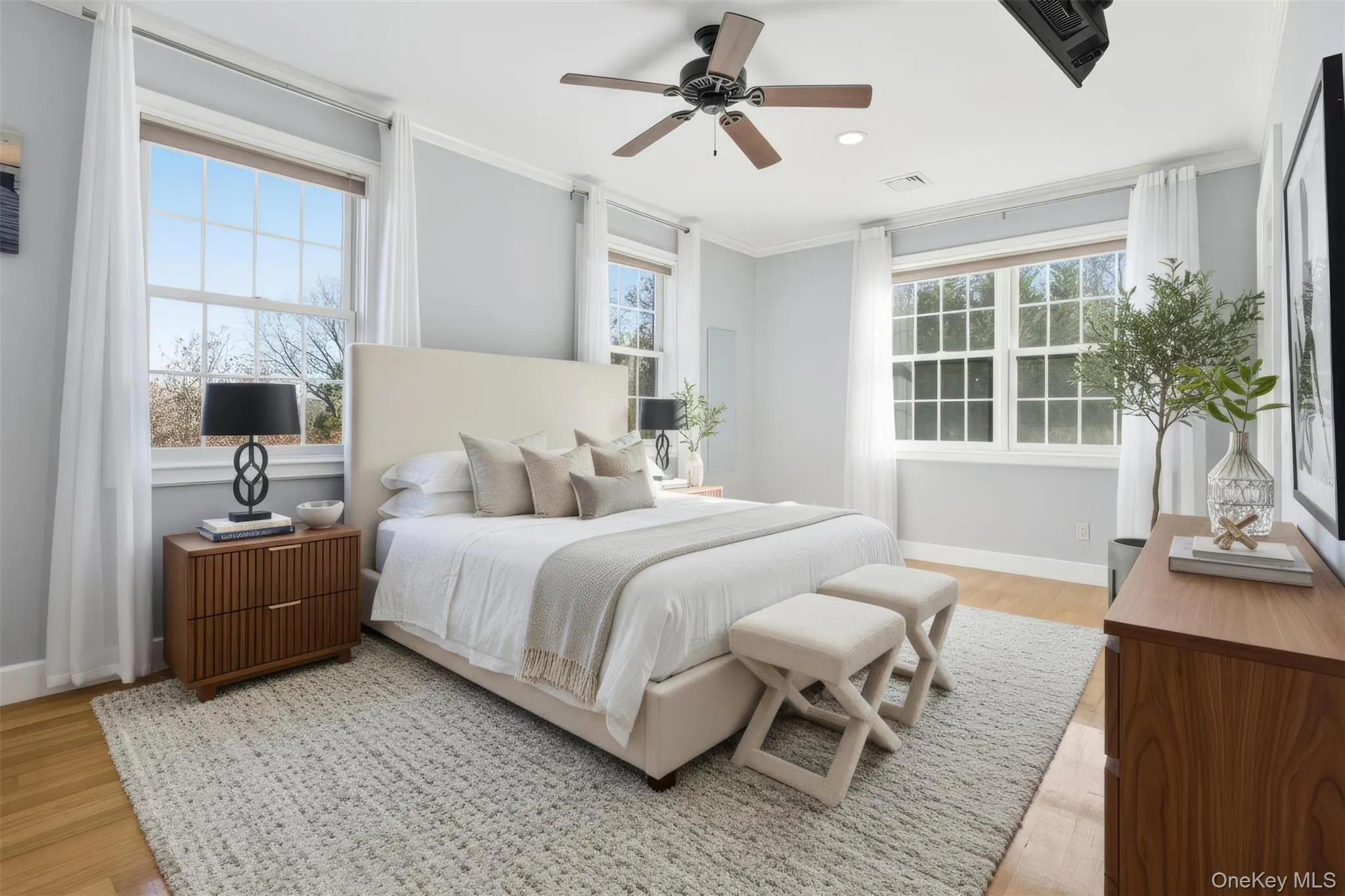 Bedroom with crown molding, ceiling fan, light wood-type flooring, and recessed lighting Bedroom with crown molding, ceiling fan, light wood-type flooring, and recessed lighting