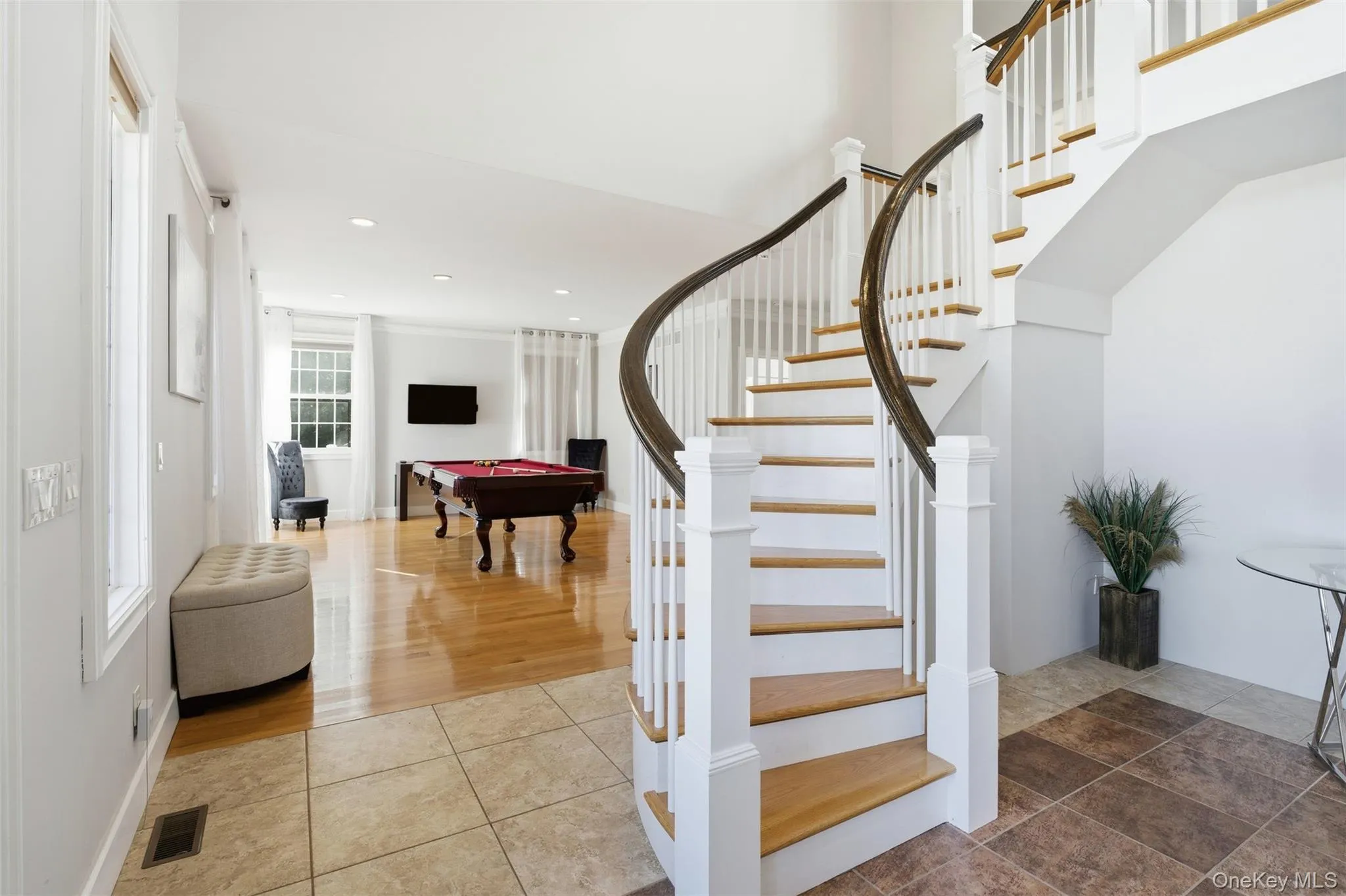 Stairway with billiards table, tile patterned floors, and recessed lighting Stairway with billiards table, tile patterned floors, and recessed lighting