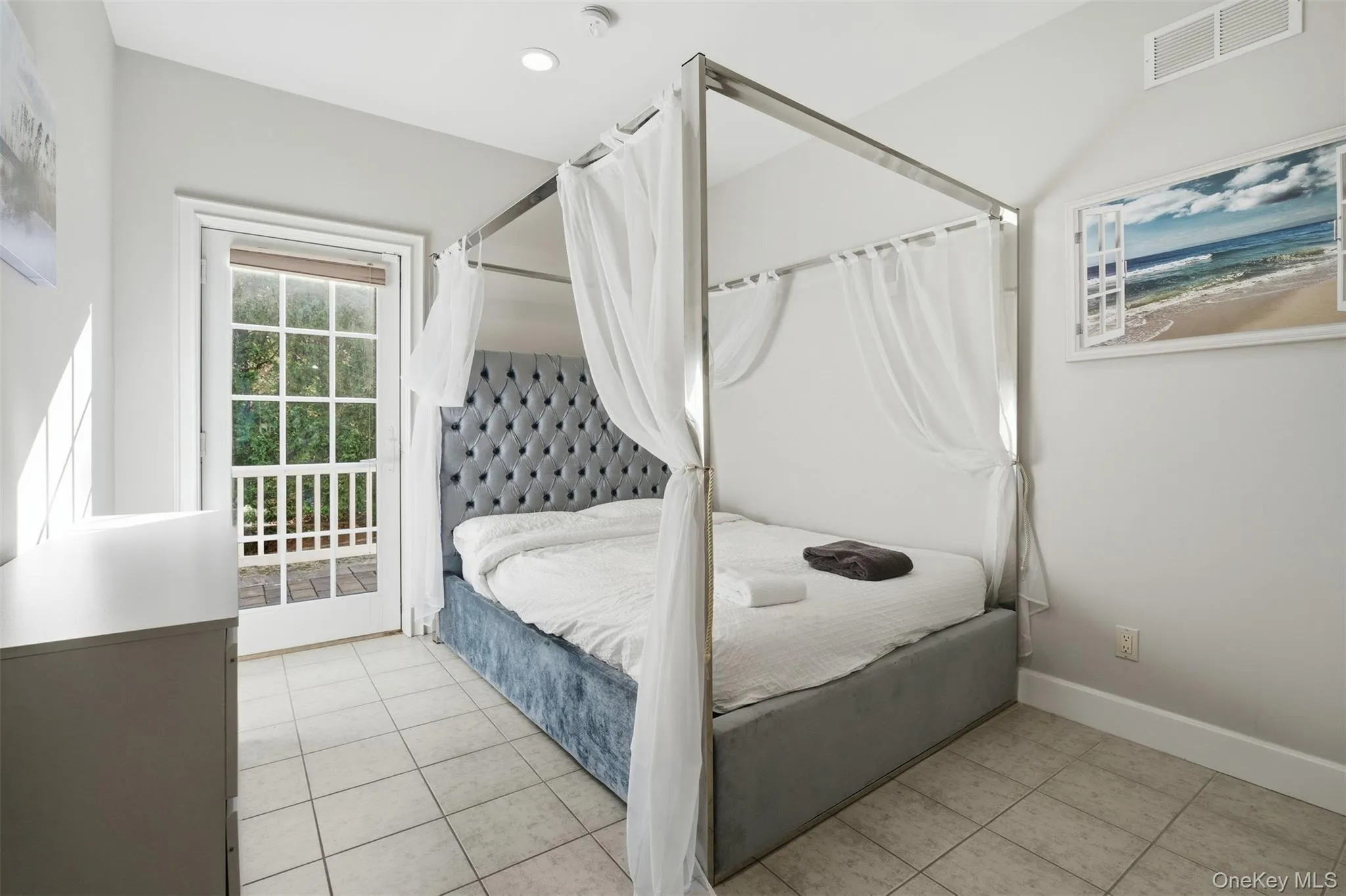 Bedroom featuring light tile patterned flooring and access to outside Bedroom featuring light tile patterned flooring and access to outside