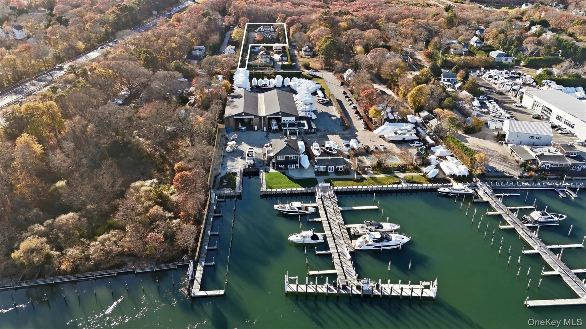 Aerial view of property and surrounding area featuring a nearby body of water and numerous boat docks Aerial view of property and surrounding area featuring a nearby body of water and numerous boat docks