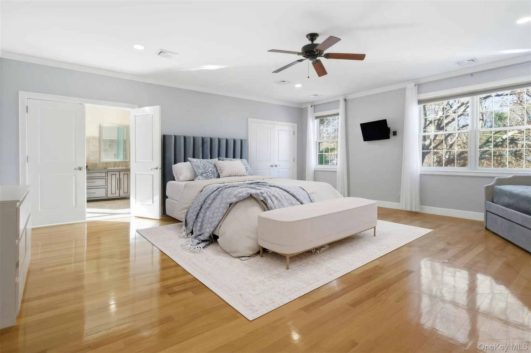 Bedroom featuring light wood finished floors, ornamental molding, ceiling fan, a closet, and recessed lighting Bedroom featuring light wood finished floors, ornamental molding, ceiling fan, a closet, and recessed lighting