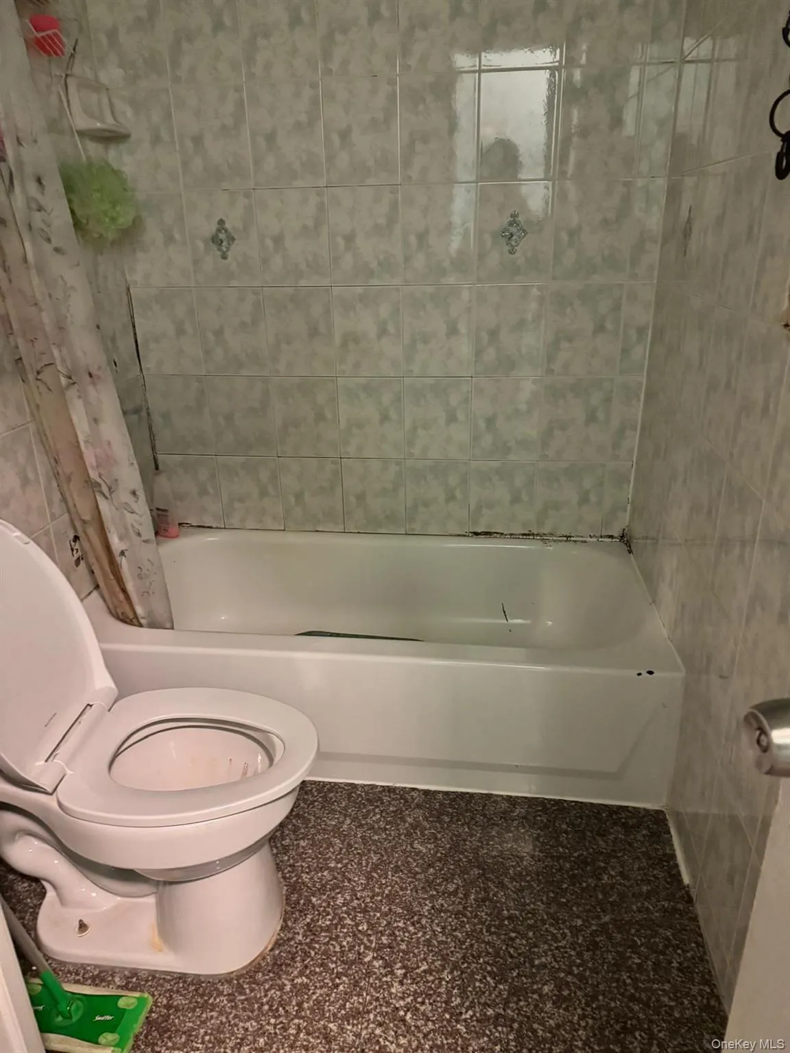 Bathroom with shower / tub combo and tile walls Bathroom with shower / tub combo and tile walls