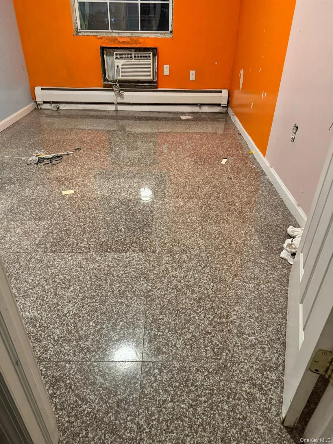 Detailed view of a baseboard heating unit and a wall mounted AC Detailed view of a baseboard heating unit and a wall mounted AC