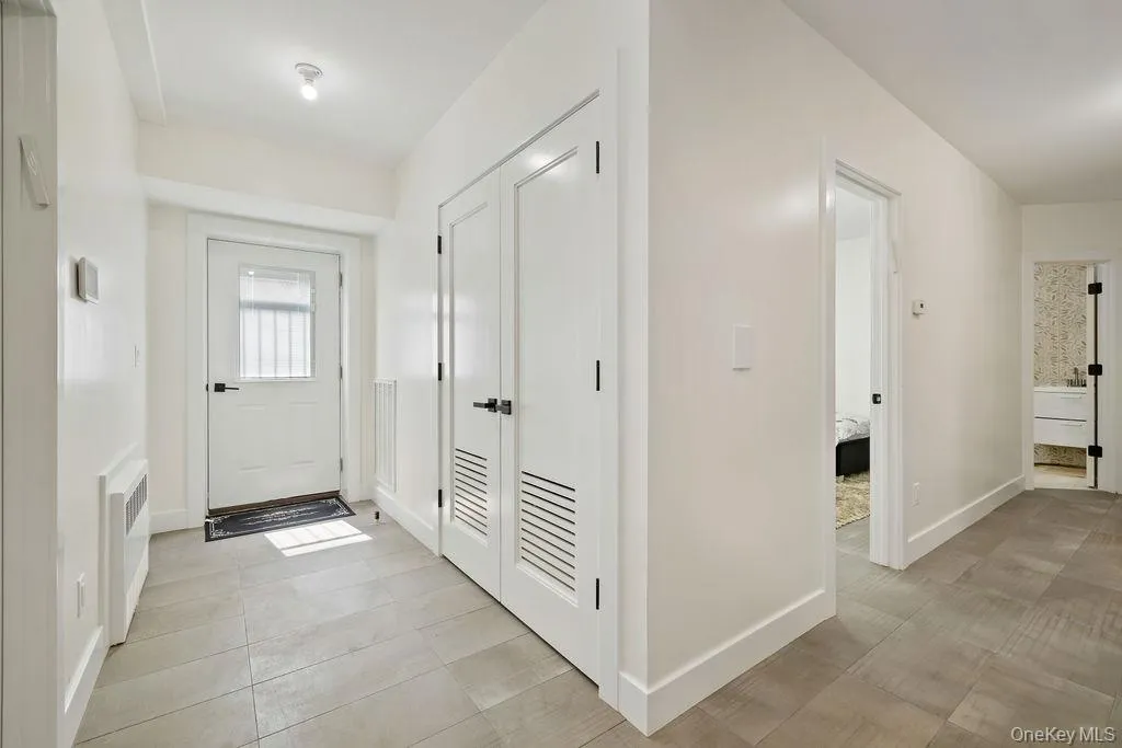 Foyer entrance featuring baseboards and light tile patterned floors Foyer entrance featuring baseboards and light tile patterned floors