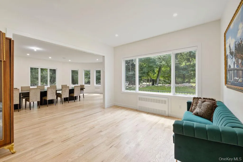 Sitting room featuring light wood finished floors, radiator, and recessed lighting Sitting room featuring light wood finished floors, radiator, and recessed lighting