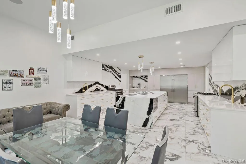 Dining space featuring light marble finish flooring and recessed lighting Dining space featuring light marble finish flooring and recessed lighting