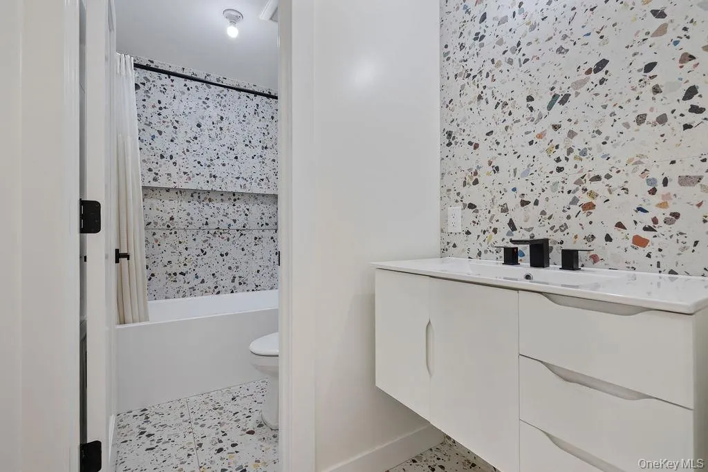 Full bathroom featuring vanity and shower / tub combo Full bathroom featuring vanity and shower / tub combo