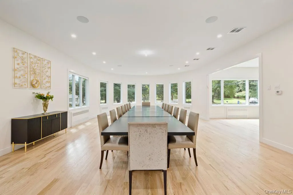 Dining space with healthy amount of natural light, light wood-style flooring, radiator, and recessed lighting Dining space with healthy amount of natural light, light wood-style flooring, radiator, and recessed lighting