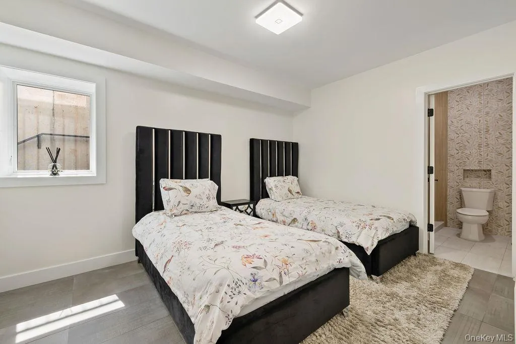 Bedroom with connected bathroom and baseboards Bedroom with connected bathroom and baseboards