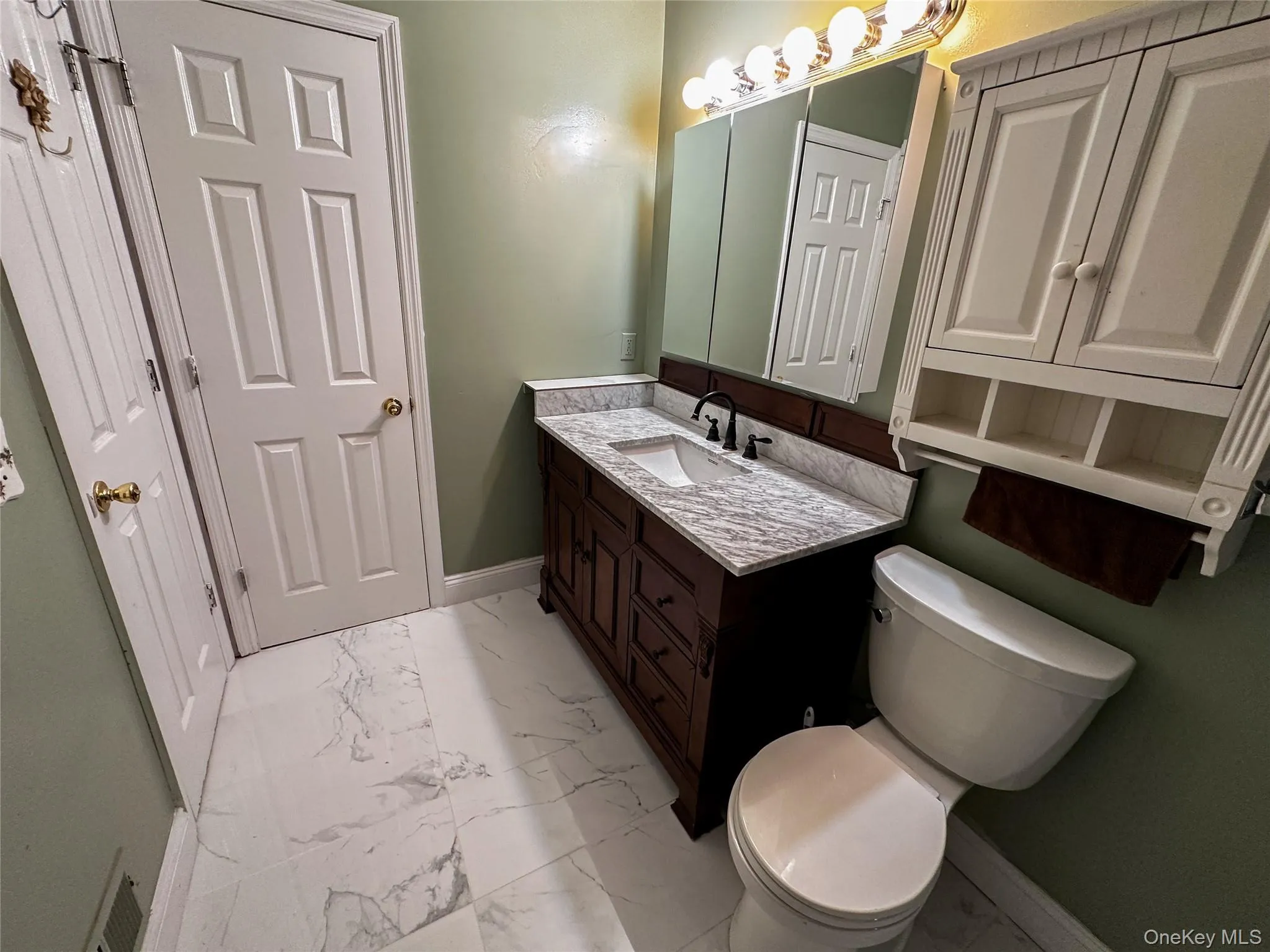 Bathroom with light marble finish floors and vanity Bathroom with light marble finish floors and vanity
