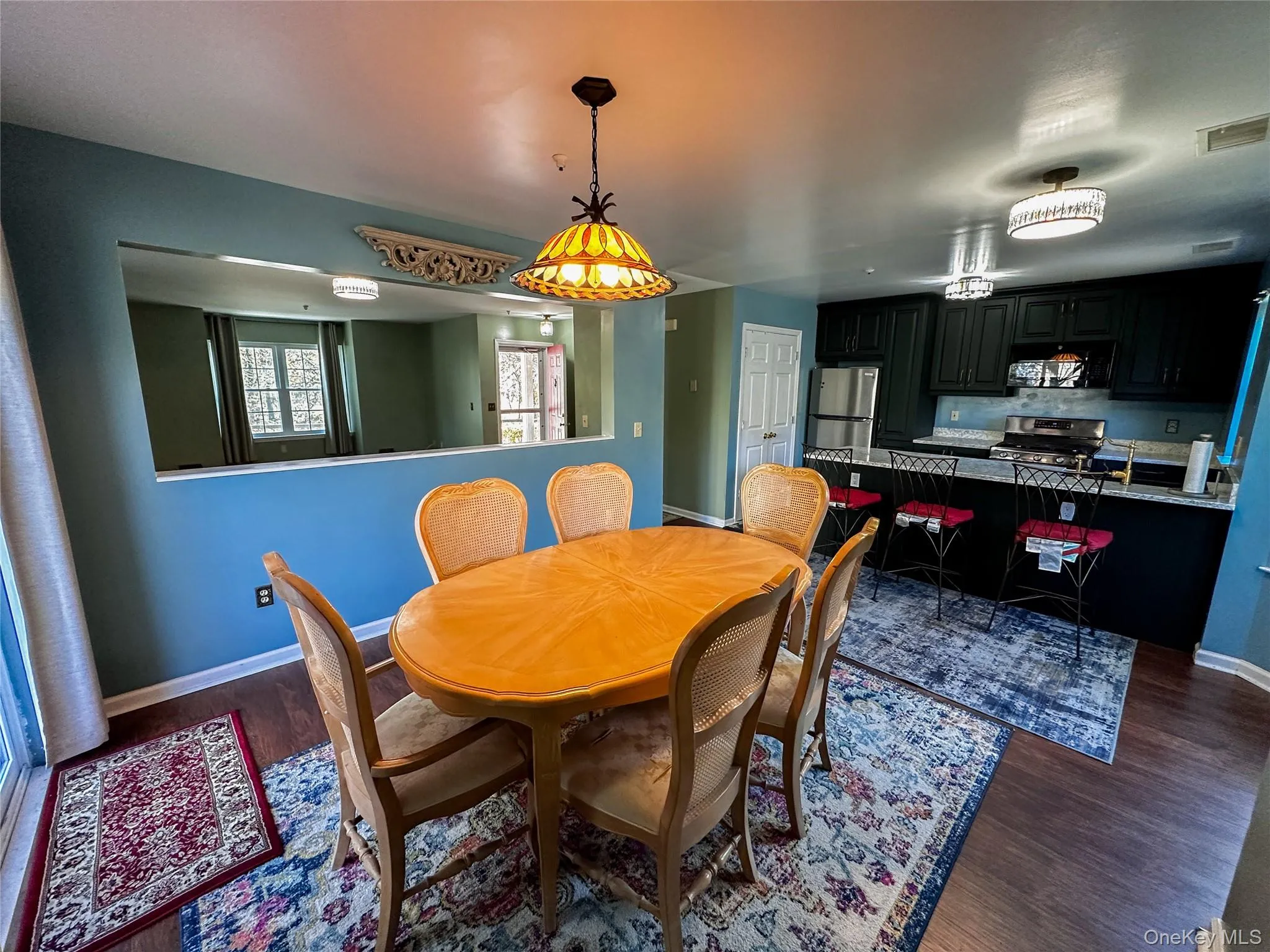 Dining room featuring baseboards and dark wood-style flooring Dining room featuring baseboards and dark wood-style flooring