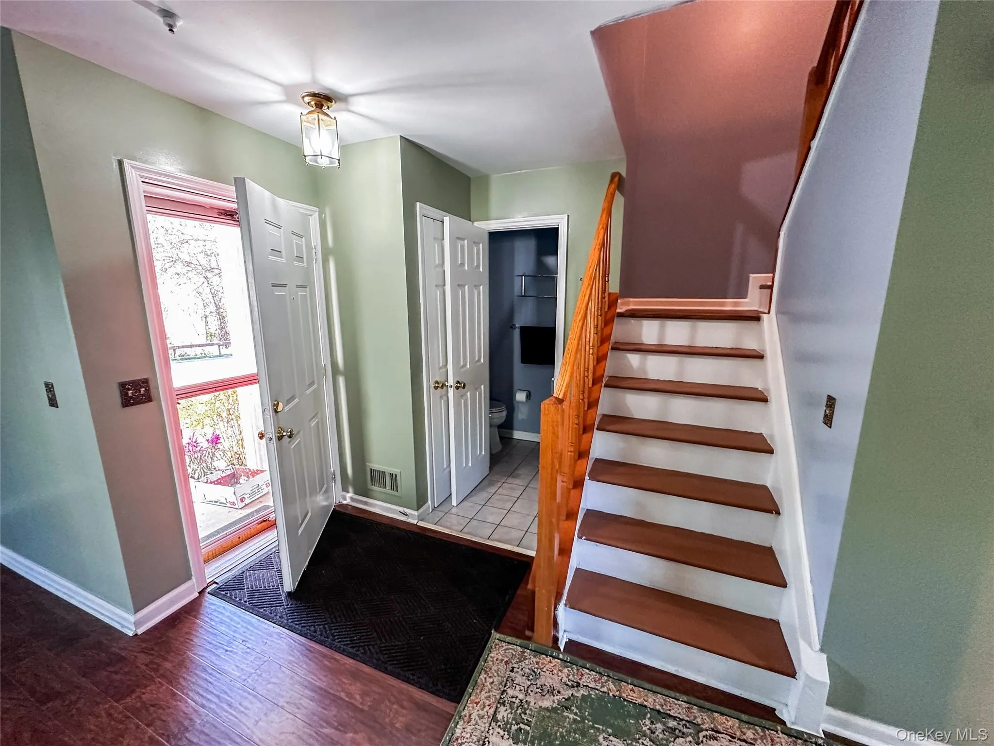 Entryway featuring stairway and wood-type flooring Entryway featuring stairway and wood-type flooring