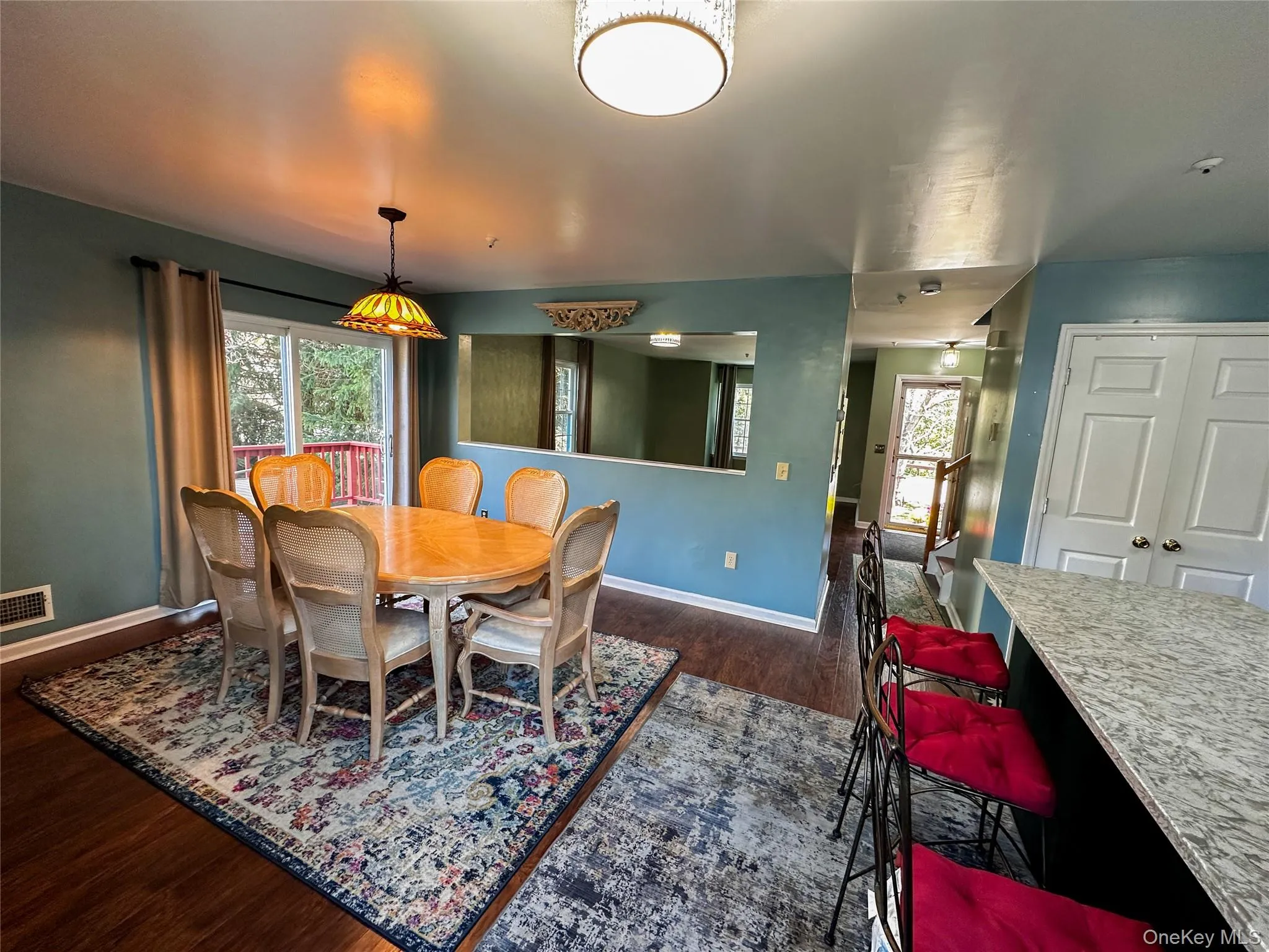 Dining area with dark wood-type flooring and baseboards Dining area with dark wood-type flooring and baseboards