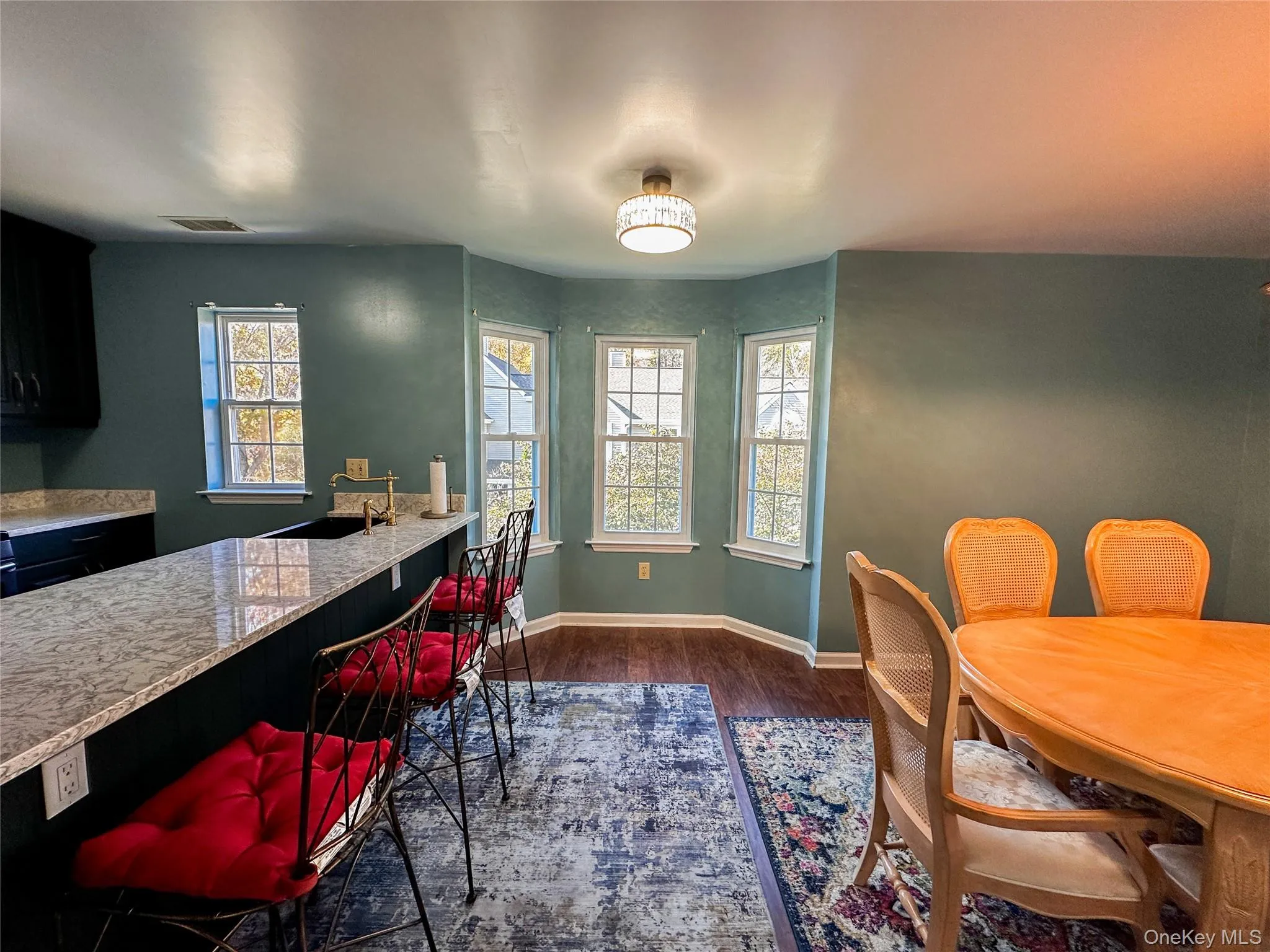 Dining area featuring dark wood finished floors and healthy amount of natural light Dining area featuring dark wood finished floors and healthy amount of natural light