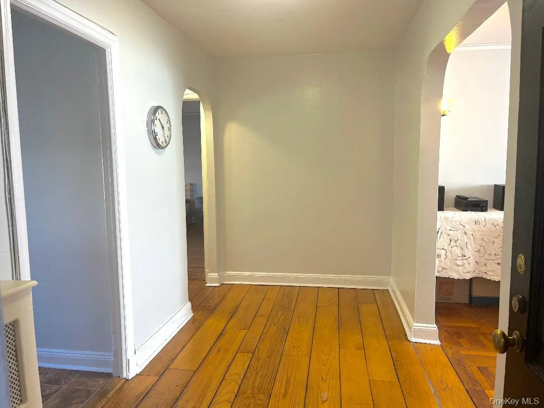Foyer featuring arched doorways and wide plank floors Foyer featuring arched doorways and wide plank floors
