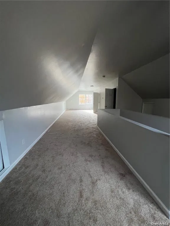 Bonus room with carpet floors and vaulted ceiling Bonus room with carpet floors and vaulted ceiling