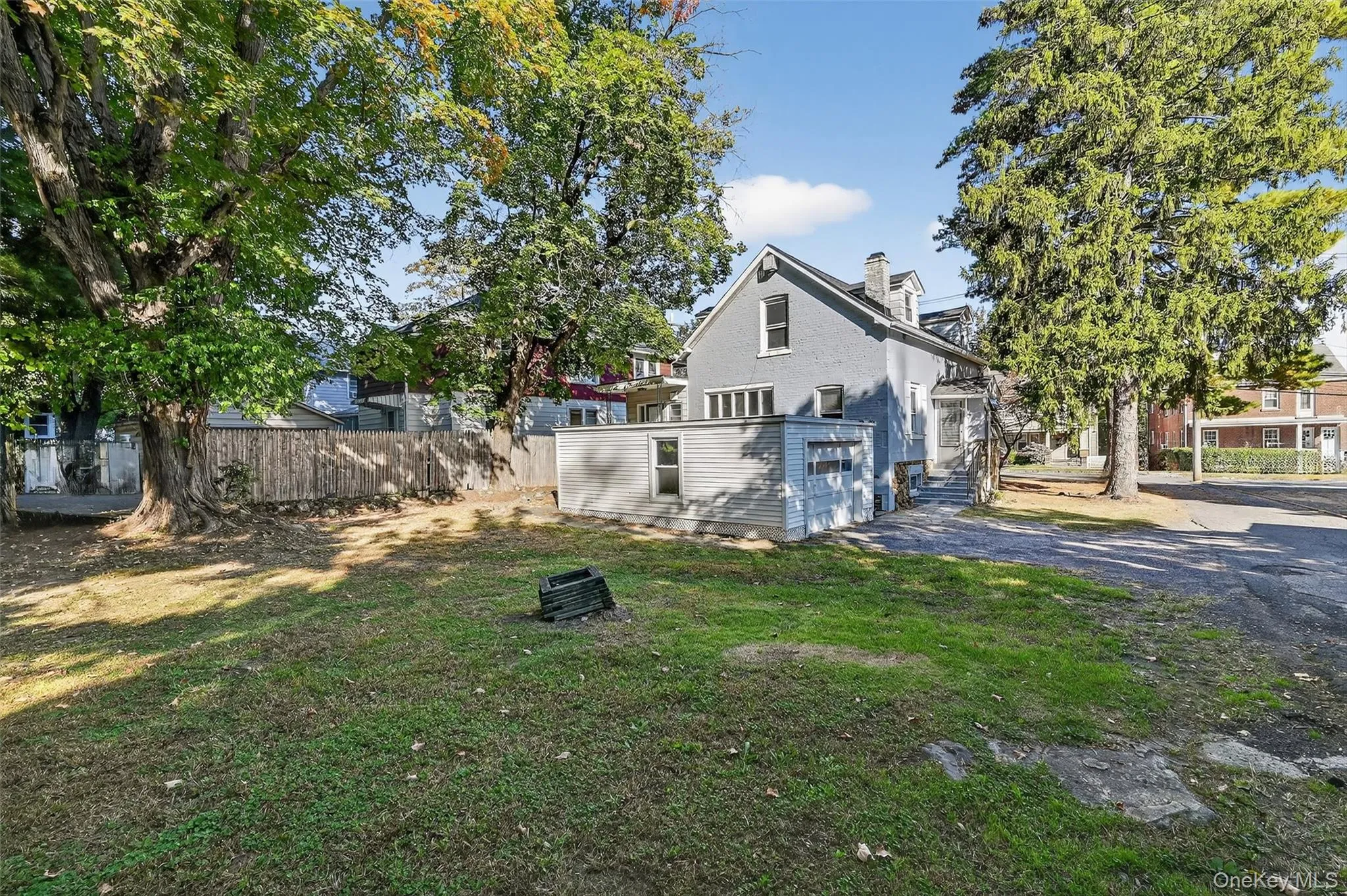 Rear view of property with a chimney and driveway Rear view of property with a chimney and driveway