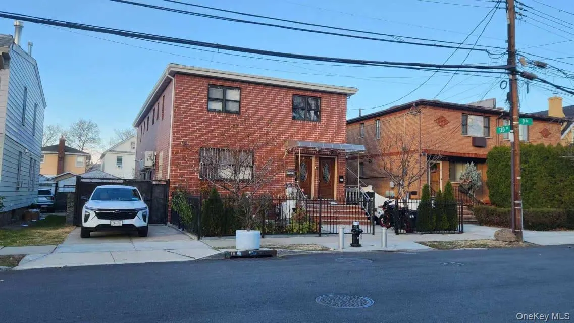 Traditional-style house featuring a fenced front yard and brick siding Traditional-style house featuring a fenced front yard and brick siding