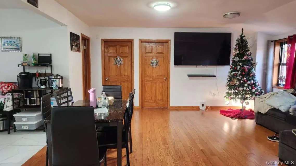 Dining area with light wood-style flooring and baseboards Dining area with light wood-style flooring and baseboards