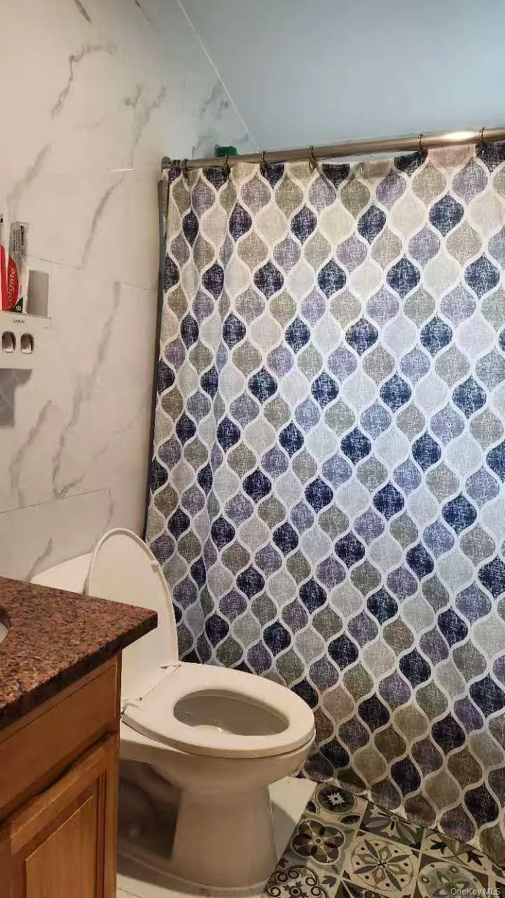 Full bath with a shower with curtain and vanity Full bath with a shower with curtain and vanity
