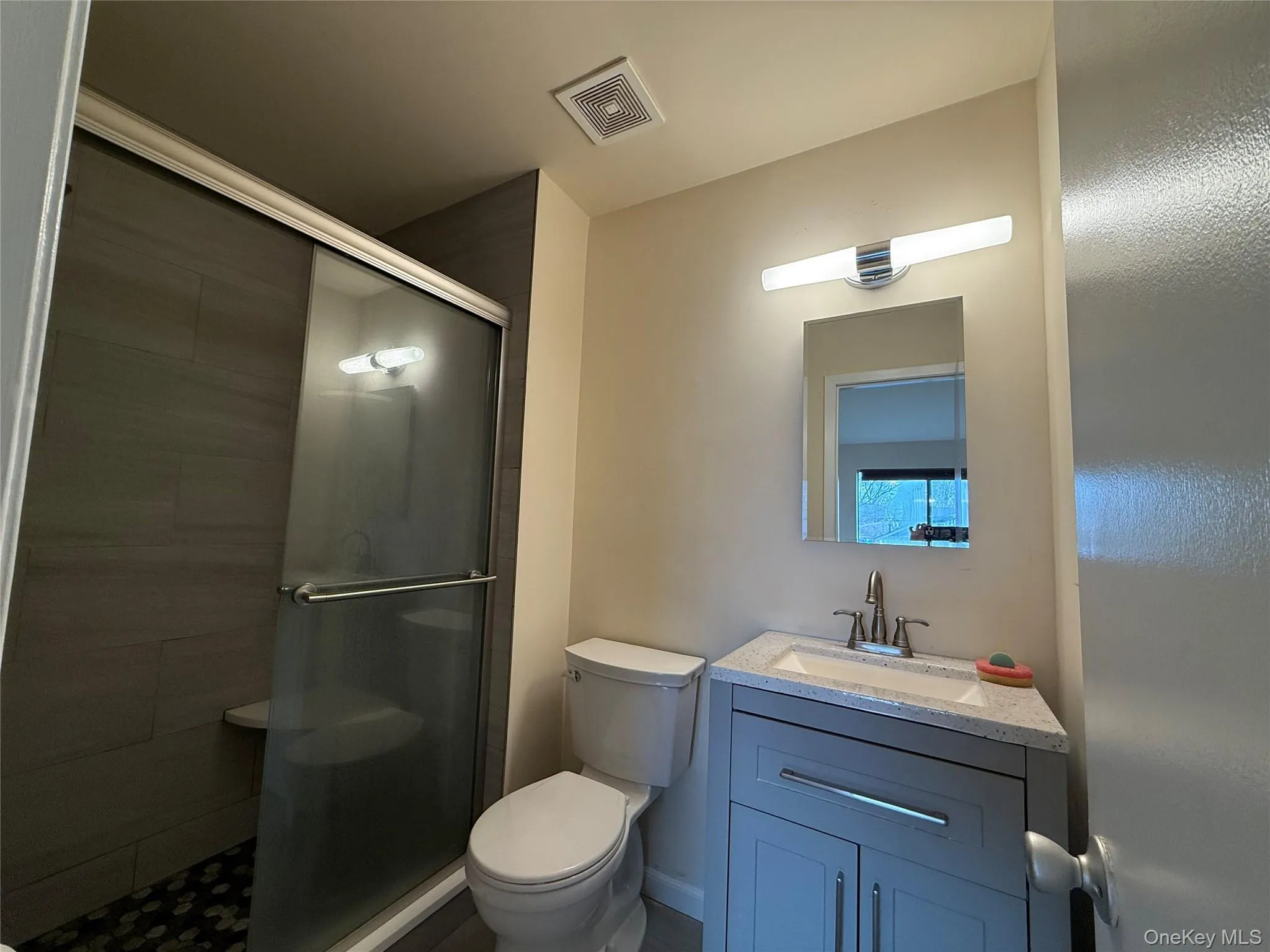 Bathroom with a stall shower and vanity Bathroom with a stall shower and vanity