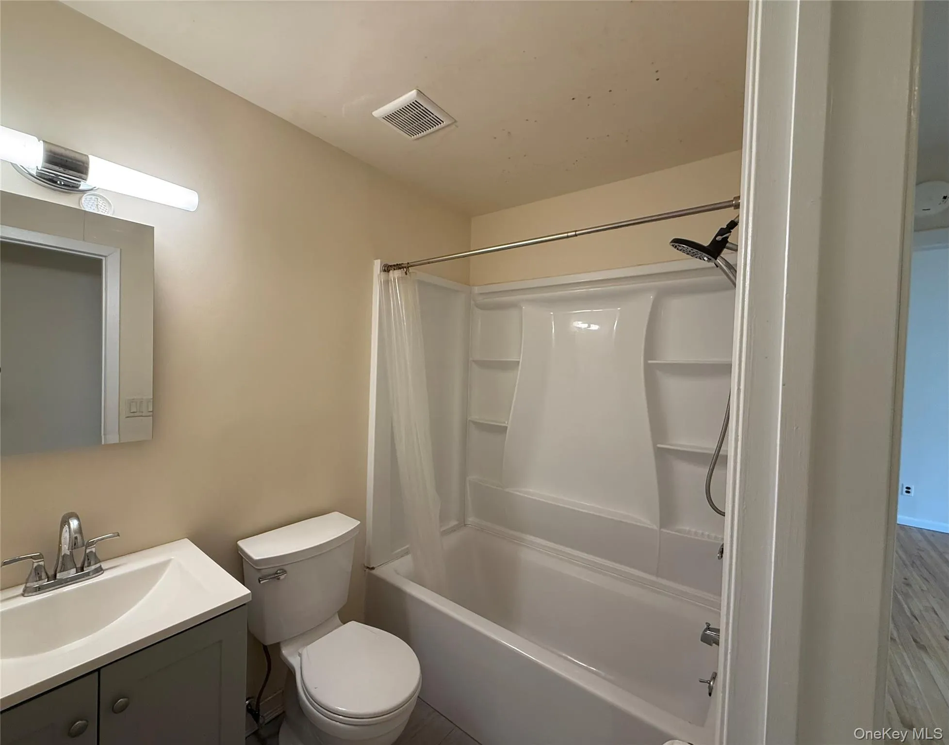 Bathroom with shower / bath combo with shower curtain and vanity Bathroom with shower / bath combo with shower curtain and vanity
